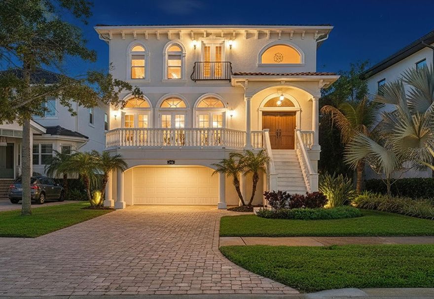 Set high above street level on the waterfront community of Davis Islands’, this elevated European-style residence offers a rare blend of architectural integrity, modern upgrades, and effortless indoor-outdoor living. Built with block construction, barrel tile roof, and a first floor elevation of 15’, this home gives its owner both peace of mind and long-term value. Upon entering, you're welcomed into a spacious open-concept living and dining area that sets the tone for the home’s elegant yet comfortable style. With 10’ tray ceilings and custom marble flooring adding a sense of scale and sophistication, while the space includes a custom bar with stone countertops, and oversized wine tower enclosed with a complementary wood finish. Designed with both gatherings and daily life in mind, the layout balances formal and casual elements, creating a warm, inviting atmosphere. The open-concept kitchen is a chef’s dream, outfitted with Viking and Sub-Zero appliances, stone countertops, a reverse osmosis water system, and white raised-panel cabinetry. A generous eat-in area, breakfast bar, and butler’s pantry provide ample space for gatherings of any size, while seamlessly connected to the living and dining areas. Located on the second level is the spacious primary suite featuring oversized windows, two walk-in closets, and a luxurious bath with dual vanities, a soaking tub, and a separate semi-frameless glass enclosed shower. Three additional guest bedrooms—two of which have updated private en-suite baths—are also located on the upper level, along with a full laundry room and an open flex space ideal for a home office or study with its built-in features.
The home’s architectural character and seamless indoor-outdoor flow are elevated by two beautifully positioned balconies—one at the front and one overlooking the private backyard. Three sets of French doors in the formal living and dining areas open to the front balcony, creating a natural extension of the entertaining spaces and inviting in abundant natural light. At the rear of the home, additional French doors from the expansive family room and kitchen lead to the covered back balcony, offering views over the pool and outdoor living area. Step outside to an oversized, screened-in lanai, where the pool and spa—complete with water features—create a tranquil backdrop for outdoor living. The built-in grill area and expansive deck space make it easy to entertain, while the artificial turf installed throughout the backyard ensures a low-maintenance lifestyle year-round. Also, from the pool area you have access to a full pool bath and additional recreation/workshop/bonus space.
Additional improvements include impact windows, renovated bathrooms, new pool pump (2025), landscape enhancements, and water heater (2022). The home is also wired for a security system and features an oversized two-car garage with an additional 200 sq ft of storage.

Located on Davis Islands, this home offers an unparalleled lifestyle in a walkable community. The neighborhood amenities, including Marjory Park Marina, Freedman Tennis Complex, the Roy Jenkins pool, and Peter O. Knight Airport. A stroll brings you to the Davis Islands Village, where you’ll find restaurants and shops. Just minutes from Downtown Tampa, Water Street, Sparkman Wharf, and the Tampa Riverwalk, this home truly offers the best of both island living and urban convenience.