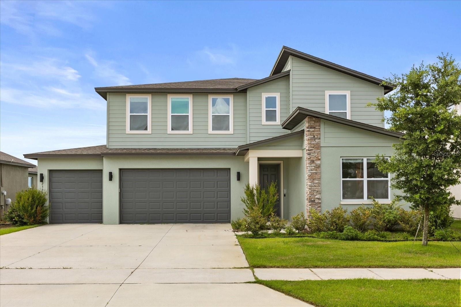 Welcome to an extraordinary home in the Hills of Minneola, where scenic views and modern features create the perfect blend for family living. This 2023 newly constructed residence by Ashton Woods offers 4,129 square feet of thoughtfully designed space, featuring 5 bedrooms and 4.5 bathrooms ideal for both families and entertaining guests. Step into an open-concept living area filled with natural light, complemented by vaulted ceilings that enhance the spacious feel. The gourmet kitchen features upgraded amenities and connects seamlessly to the living room, making it perfect for gatherings. A first-floor en-suite bedroom adds flexibility, serving as a guest suite or mother-in-law suite. An upstairs loft and a downstairs bonus room for an office provide additional options for work and leisure. Set on the top of a hill, this home boasts stunning views of rolling hills, ensuring privacy with no backyard neighbors. The oversized primary suite serves as a peaceful retreat, while wood look porcelain tile throughout the living areas combines style with practical durability. The vibrant Hills of Minneola community enhances your living experience with walking trails, parks, and green spaces nearby. Quick access to major highways makes trips to Clermont, Winter Garden, and Downtown Orlando seamless. Families will benefit from top-rated schools, and the upcoming AdventHealth Minneola hospital adds convenient healthcare options. Discover elevated living in a tranquil setting that offers comfort, community, and connection. Schedule a tour to experience this remarkable home today.
