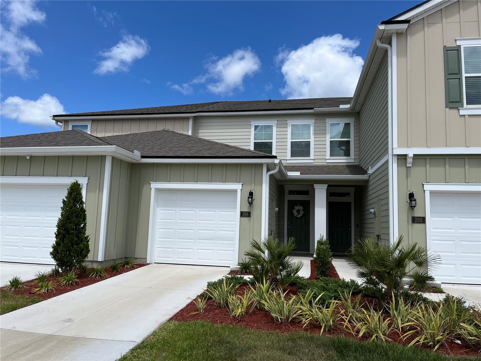 The Trails is a new gated townhome community in the popular Palm Coast area. This home is on the water and provides serene lake views. The open concept floorplan is inviting for family activities and entertaining. The kitchen has quartz countertops with a large island, plenty of cabinet space, and a walk in pantry. For convenience, the pantry has automated lighting, and the island has a countertop disposal on/off air-switch as well as a cabinet pull-out trash bin. The bedrooms, gathering room and screened-in patio all have lighted remote controlled ceiling fans, and smart switches control the outdoor, kitchen and bedroom lighting. Located off Belle Terre Parkway, there is easy access to I-95 and US-1. Shopping, dining and entertaining includes Palm Coast Town Center, only minutes away.