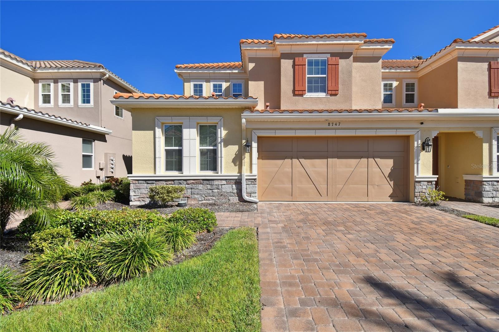 Step into this breathtaking end-unit home, thoughtfully enhanced with over $40,000 in premium upgrades, ensuring elegance, comfort, and modern convenience. Featuring three spacious bedrooms, two and a half luxurious baths, and a generously sized two-car garage, this meticulously designed residence is nestled within a gated community adorned with impeccable landscaping. From the moment you arrive, the home's timeless sophistication shines through—a striking barrel tile roof, a charming pavered driveway, and lush surroundings set the scene for refined living. Inside, an open and light-filled floor plan welcomes you with stylish tile flooring that extends throughout the main level. At the heart of the home, the chef’s dream kitchen boasts stunning custom cabinetry, sleek granite countertops, and abundant workspace for culinary creativity. The first-floor primary suite is a sanctuary of tranquility, featuring rich wood flooring and a spa-like en-suite with dual sinks, a grand walk-in shower, and a custom-designed California Closet. Every corner reveals thoughtful touches—an exquisite glass wine closet, a convenient laundry room, and a modern half bath. Step outside to the screened-in patio, complete with a decorative fenced area, perfect for pets or peaceful outdoor lounging. Upstairs, a versatile loft awaits, ready to serve as a secondary living area, a home office, or an inviting playroom. Elegant details, including trim and wainscoting wall panels, add warmth and character to the space. The upper level also hosts two generously sized bedrooms, a beautifully appointed full bathroom, and plush carpeting throughout, creating an ambiance of comfort and relaxation. Set against a backdrop of serene wetlands, this home offers both privacy and natural beauty. Remarkably, it has weathered hurricanes Helen and Milton without damage, and with no flood insurance required, it delivers invaluable peace of mind. Perfectly positioned near the Veterans Expressway, Westfield Citrus Park, Tampa International Airport, and Florida’s breathtaking beaches, this stunning home seamlessly blends convenience, style, and tranquility. Don’t miss the opportunity to make this beautifully designed, move-in ready home yours!