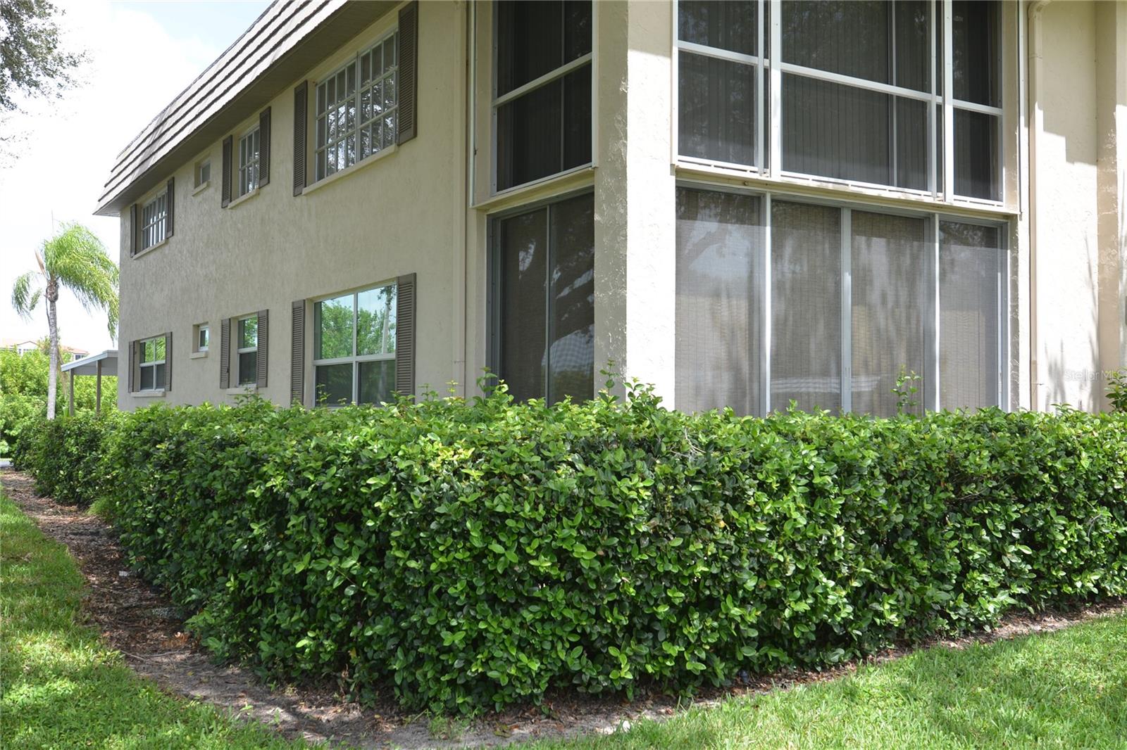 West of the Trail, FURNISHED remodeled light and bright 2 bedroom, 2 bath condo, a ground-floor, end unit with lots of windows and easy access. Enjoy a front lanai that is fully enclosed with glass that slides open and is screened for year-round enjoyment. The Living Room is tasteful in Modern Decor and Filled with Light. The Second Bedroom has plenty of room as an Office/Den or bedroom. Turnkey furnished with everything you will need, including a washer and dryer. A second entry door at the carport allows easy access. With only 32 condos in this complex, it creates the feeling of a peaceful retreat in a boutique resort. Enjoy the Florida lifestyle in the large heated pool, or play tennis / pickleball on the brand new court. Super location, tucked just along the Intercoastal Waterway offering the Serenity of this Natural Tree-Lined setting. It is a short stroll south to the Bayfront fountain and dock to Watch the Sunset. Explore the 60 acre Phillippi Estate Park from the walking/biking path entrance one block east with Walking Trails, Gardens, Gazebo, Fishing Pier, Kayak Launch, Playground, Archaeological Dig, and weekly Farmers Market. A Siesta Key Beach access is less than 2 miles away, and 1/4 mile away are restaurants & a bakery. Downtown Sarasota is just minutes away with Boutique Shops, Fine Dining, Galleries, Theaters. Amazing sunsets are included.