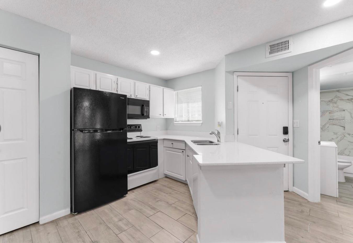 Recently Remodeled & Move-In Ready. This bright 1-bed, 1-bath condo at The Plaza at Millenium overlooks the community pool, blending low-maintenance living with a highly desirable central Orlando address near The Mall at Millenia and Universal Studios. Open-concept layout with durable tile floors throughout Gourmet kitchen featuring sleek quartz countertops. Spacious living room flowing onto a screened patio—ideal for morning coffee or evening relaxation overlooking the pool. Oversized bedroom with a walk-in closet. Spa-inspired bathroom featuring new vanity and marble-tiled shower/tub. HOA dues include water, sewer, and trash.