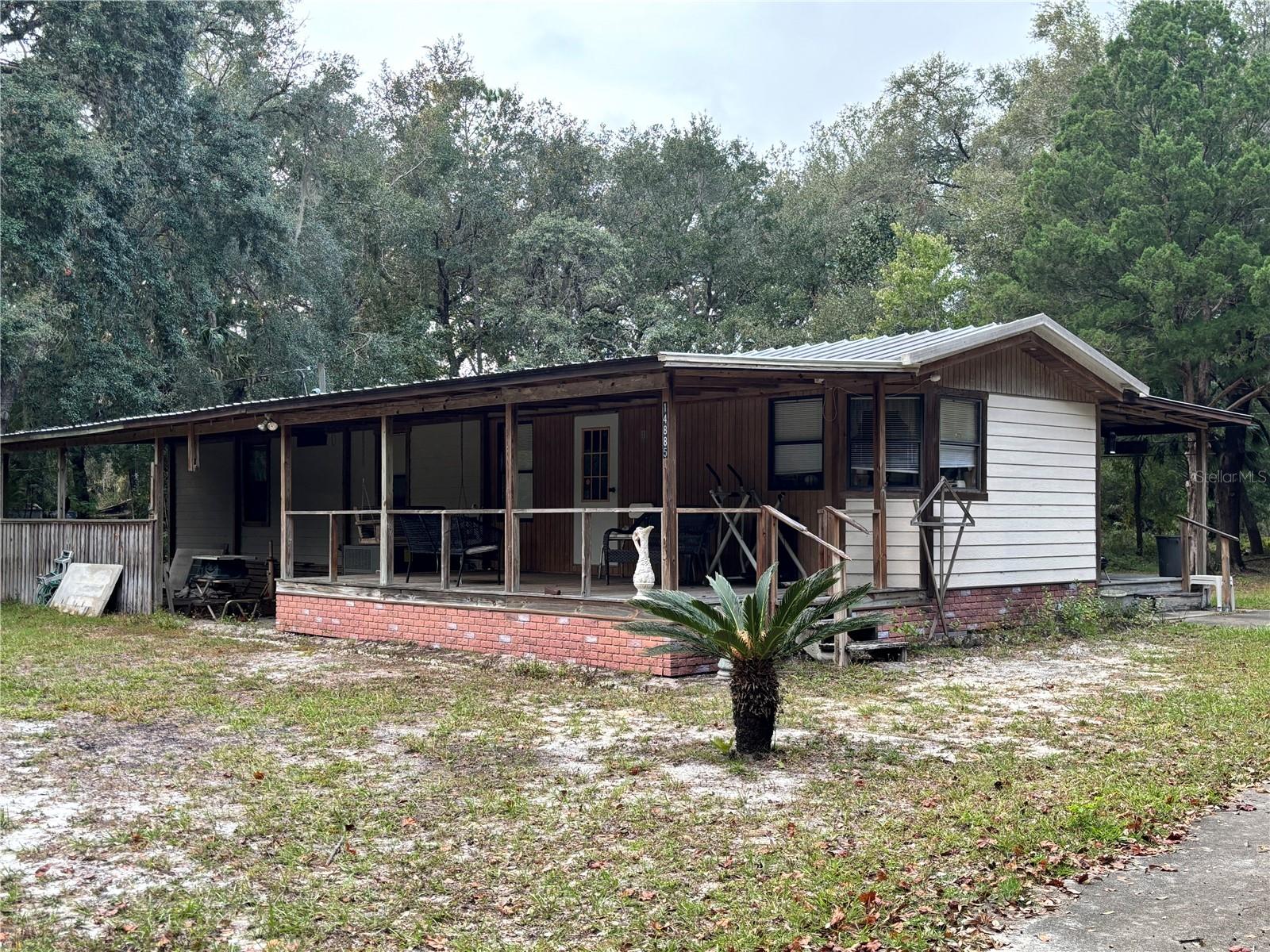 Located on a dead end street in a quiet community of Fort McCoy, this well-maintained 2 bedroom 2 bathroom mobile home offers comfort, space, and serenity. The eat-in kitchen offers plenty of cabinet space and is equipped with a gas stove. The living room is spacious and welcoming for family and friends. Off of the living room is an addition that serves as another living space, with plenty of windows to showcase the property outside. An inside laundry room provides comfort and extra space for storage, with its own door outside. The property size is .76 acre and has two carports and an outstanding workshop with electricity, perfect for those projects you've been wanting to get done. Come see it today!
