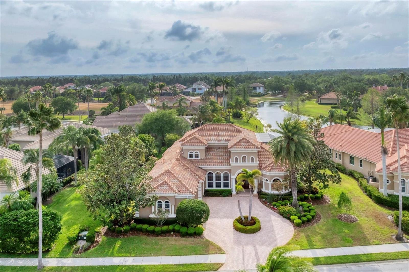 An amazing family resort style home, located in The Dominion, one of the most desirable neighborhoods in Lakewood Ranch Country Club! This Todd Johnson masterpiece features the perfect floor plan, flexible, spacious and maximizing the enjoyment of the serene and peaceful lake, preserve and golf course views.
This four-bedroom, five-and-a-half-bath home showcases stunning architectural details including intricate crown moldings, tray ceilings, stately all wood built-ins and 2 cast stone fireplaces, one in the living room and the other on the spacious lanai. The chef's kitchen features all wood quiet close cabinetry, new Subzero refrigerator and freezer, GE Monogram double ovens, GE Monogram 6 burner range and a newly redesigned kitchen island with gorgeous rich chocolate brown quartz countertops and custom backsplash make this kitchen one to remember. The owner’s retreat boasts wood flooring with an extended sitting area, large his and hers walk-in closets and a lavish master bath with dual marble vanities, exquisite wood cabinetry including linen towers, large walk-in shower with intricate tiling and jetted soaking tub so one can truly relax and unwind. Situated on the other side of the home for complete privacy the mother-in-law suite is perfect for that long term guest with an ensuite full bath, mini refrigerator with room for a coffee bar, beautiful bay windows framing the sitting area and a built-in desk with elegant all wood cabinetry and storage. Towards the back of the home, you will find another guest suite with full bath and a spacious office with large picture window overlooking the expansive lake view.
As you make your way upstairs, you will notice the intricate iron railing leading you to the open bonus room with private guest suite with a full bath and covered balcony. Back on the first-floor, exit through the disappearing sliders from the great room to the beautiful outdoor living space with spectacular lake view, where you can refresh in the saltwater, heated pool and spa and sit back under the huge, covered lanai with spectacular outdoor kitchen with 2 refrigerators, grill, boiler, sink and stunning cast stone fireplace. OTHER NOTABLE FEATURES INCLUDE: new pool heater in 2025, landscape lighting throughout the yard, newer carpeting in guest bedrooms, AC units replaced in 2024 and 2025, new Subzero refrigerator Dec. 2024, newer dishwasher 2018, new screening on lanai cage in 2023 and 6 video surveillance cameras for your peace of mind. Lakewood Ranch Country Club offers the ultimate Florida lifestyle with a private Country Club with 3 luxurious clubhouses, 4 golf courses, 18 Hard-Tru lighted tennis courts, pickleball courts, state of the art fitness center, aquatic center, parks, walking trails and so much more. Membership is optional and no waitlist. All within minutes of the UTC Mall, fabulous dining and shops, Lakewood Ranch Main Street, polo fields, Benderson Park, and the much-anticipated new home for Mote Marine Aquarium. Plus, don't forget you're only a short drive to the world's top-rated beaches! This is truly luxury at its finest, schedule your private showing today.