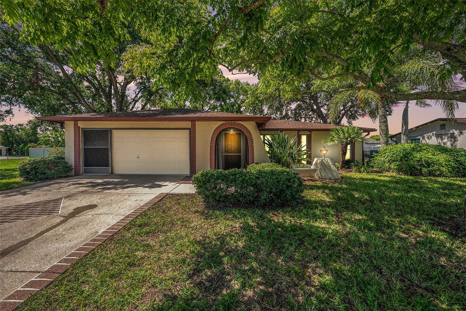 Beautiful and well-maintained 2 bedroom, 2 bath, 2 car garage home in the New Port Richey community of Embassy Hills, a northern suburb of Tampa. This move-in ready home has curb appeal that draws you in with brickwork accents and mature landscaping. There’s a spacious living room and the kitchen features upgraded cabinets with soft-close doors and drawers along with a white tiled backsplash and breakfast bar. Ceiling fans are in each room, laminate flooring in main areas with ceramic tile in kitchen and baths. Two sets of sliding glass doors lead you out to the covered and screened back porch, perfect for enjoying the Florida lifestyle. Master bath has a shower, while the second bath has an accessible sit-down tub. You’ll appreciate the newer upgrades of this home - Roof was replaced in 2024 and A/C in 2023, newer tankless water heater and double-pane windows. Extra features include sliding screen doors for the garage, screened front entry, hurricane shutters and utility shed. Appliances included in your purchase are Refrigerator, Range, Microwave, Dishwasher, higher-end front loading Washer & Dryer and Water Softener. If needed, the Den may well lend itself to being enclosed as a third bedroom. SAVE MONEY with no HOA or CDD payments. Property was remediated in 2013 and is fully insured. Full documentation is available. In flood zone X, which does not require flood insurance. LOCATION: Conveniently located near US 19 between State Roads 52 & 54, you're close to nearby beaches, 5 minutes to Publix, 7 minutes to Walmart, 45 minutes to Tampa International Airport and close to all the restaurants, shopping and entertainment for which the Tampa Bay area is known. Schedule your showing today!