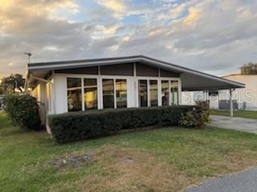 Welcome to this cozy, fully furnished manufactured home that’s nestled in the Bonfire Mobile Home Park, a well established 55+ resident-owned (co-op) community with friendly neighbors and lots of extras. This home is perfect for part-time or year round living. There are 2 bedrooms, 2 bathrooms, a dedicated dining area just off the kitchen, and a lovely living room with wood flooring that adds feelings of warmth and calm. From the living room, open the sliders and walk into the bright, peaceful enclosed porch that overlooks the front yard. With one wall full of windows you’ll feel as if you’re outside but without the hassle of bugs and heat! A bonus is the exterior door leading from the porch to the carport. This community is located along scenic Haines Creek with direct access to Lakes Eustis and Griffin and the rest of the Chain of Lakes. Community extras include a pool, clubhouse, shuffleboards and a large secured area where residents may store items such as boats or boat trailers at no additional cost. Residents love the friendly atmosphere and vibrant social life in this peaceful, waterfront community. Come experience the Bonfire lifestyle!