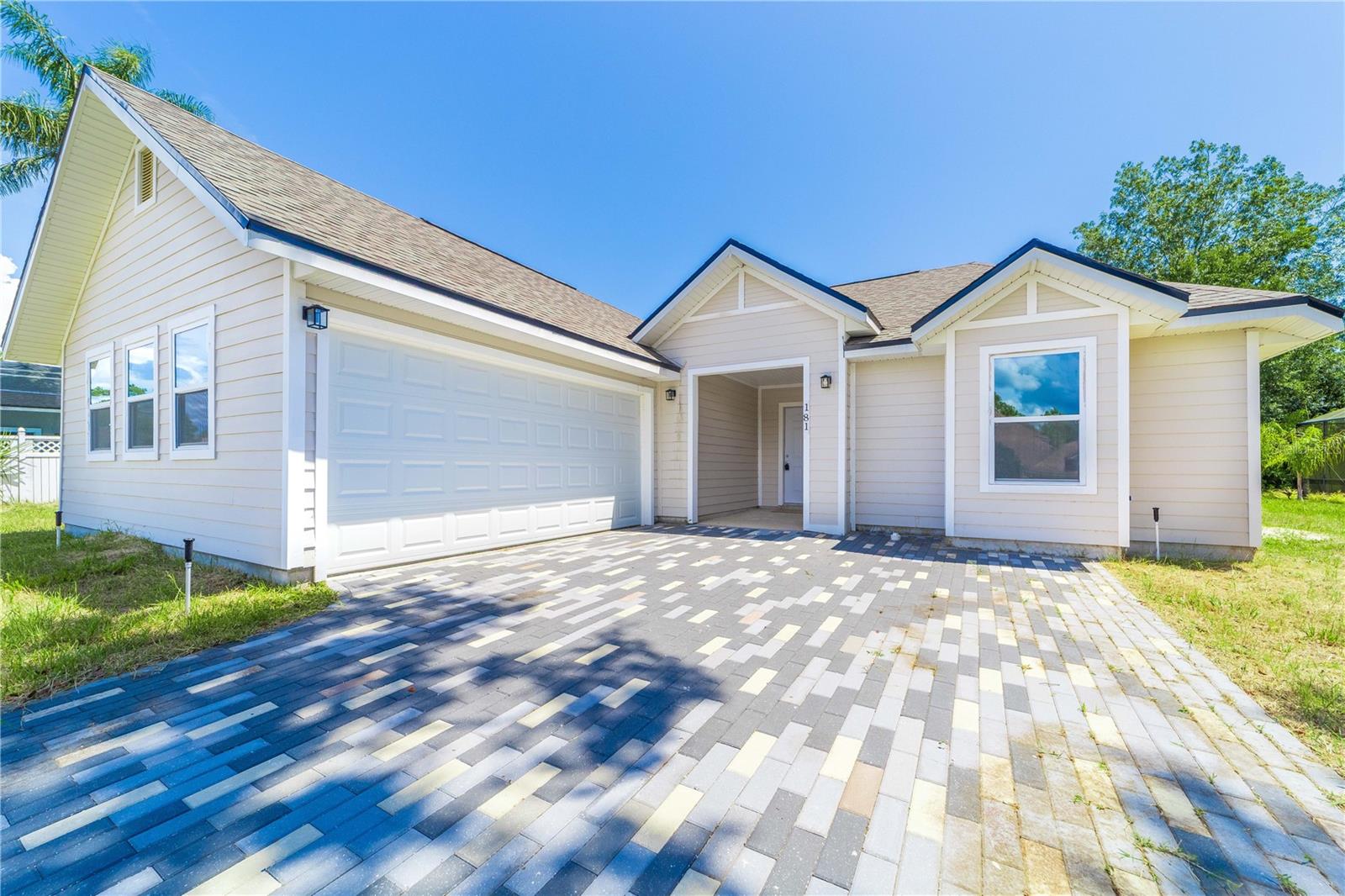 Welcome to 181 Fonseca Drive—a pristine, never-lived-in home located in the highly desirable Tuscany section of St. Augustine Shores. Situated just 8 minutes from the Intracoastal Waterway and 12 minutes from the beach, this brand-new residence offers the perfect balance of coastal convenience and natural serenity. Set on a peaceful 0.3-acre cul-de-sac lot backing to a lush nature preserve, this home provides privacy and a tranquil backdrop for everyday living or vacation escapes. Whether you're seeking a primary residence, seasonal retreat, or investment opportunity, this versatile property delivers. Inside, the expansive split floor plan is filled with natural light and enhanced by stylish wood-look tile throughout the main living areas. The open-concept kitchen is a chef’s delight, featuring stainless steel appliances, stone countertops, a designer tile backsplash, and a large island—ideal for meal preparation and casual entertaining. The kitchen flows effortlessly into the spacious great room, perfect for gathering with family and friends. Step through the sliding glass doors to a covered lanai and oversized backyard—an inviting canvas ready for your custom outdoor retreat. The primary suite serves as a private sanctuary with a luxurious en-suite bath that includes a walk-in shower, garden tub, dual vanities with granite countertops, and an oversized walk-in closet. Three additional guest bedrooms, a second full bath, a convenient half bath, a two-car garage, and generous storage complete this well-appointed home. Ideally located just minutes from historic downtown St. Augustine, Crescent Beach, shopping, dining, and I-95, this home combines modern comfort with unmatched lifestyle convenience. Residents of St. Augustine Shores enjoy access to outstanding amenities, including an 18-hole public golf course, scenic walking and biking trails, tennis and pickleball courts, an Olympic-sized pool, a fishing pier on the Intracoastal, and the Riverview Club—offering year-round social events and activities. Whether you’re searching for a full-time residence, a vacation home, or an income-producing rental, this turnkey property embodies the best of coastal Florida living. Schedule your private showing today.