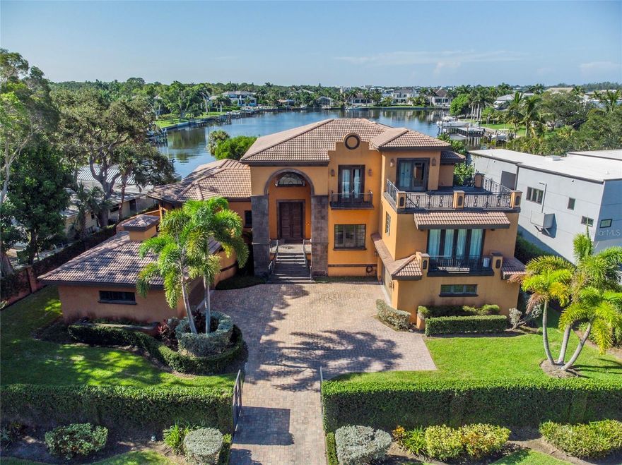 Welcome to this captivating property located in the beautiful San Remo Estates and minutes away from Siesta Key Beaches and downtown Sarasota. This house is located in an incredible location so close in proximity to great schools, restaurants, cultural destinations, and parks. This 5,160 SqFt waterfront property is nestled on a 18,416 SqFt lot behind a private gate. As you enter the front entrance, walk into the formal living area next to a private formal dining area which features a bar between the two, great for entertaining with natural light throughout the house. The spacious primary bedroom is on the main floor located off of the formal living area with two luxurious walk-in closets, featuring a serene spa-like bathroom with a beautiful tub, walk in shower, two bathrooms and dual sinks.  Perfect home for entertaining and features a bar room upstairs with a video wall to entertain guests and balcony looking out to Siesta north bridge and Sarasota Bay to watch the sunset to end your day. With a seamless flow from the living area to the chef's kitchen with brand new Viking appliances, the open-concept layout is an entertainer's dream with ample space to gather. Designed to entertain, the kitchen offers a massive center island and sliding doors to the poolside terrace. Complete with pool & spa, outdoor entertaining that is complemented by an outdoor fireplace. The three en-suite bedrooms upstairs feature separate areas to give guests the utmost privacy and comfort. Two of the bedrooms featuring a private balcony for guests as well as a sitting area with plenty of room for an office or library between the two bedrooms overlooking Roberts Bay. Expansive Bay and City Views with easy access to Intercoastal Waterway, Sarasota Bay, and Gulf of Mexico. This home is a must see!