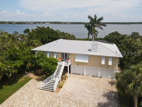 Come and make memories to share and last a lifetime. Waterfront living is not for the faint of heart, the risk/reward should be taken into consideration...just like anything else. The upside is potentially wonderful and life changing, give yourself the permission to slow down and enjoy the moment and the journey. This home offers 3 bedrooms 2 baths, beautiful kitchen with 2 large pantries, office, three car garage, boat dock, large screened pool on a one acre parcel with deeded beach easement. The dock is ideal for fishing, kayaking, canoeing, launch your skiff, jon-boat with kicker to use in deeper water. No motorized boats allowed or jet skis, too shallow. The Sarasota County barrier islands have taken a hit from the 2024 hurricanes, Manasota Key is no exception. Much still has to be done and you have the opportunity to make this home yours; leave, return, and enjoy all over again. 7505 stands tall and has dealt with debris of all shapes and sizes crossing her path in the wake of the storms, she's ready for a new owner who comes to be protected and protect as the sun rises and sets over the Intracoastal Waterway and Gulf of Mexico.