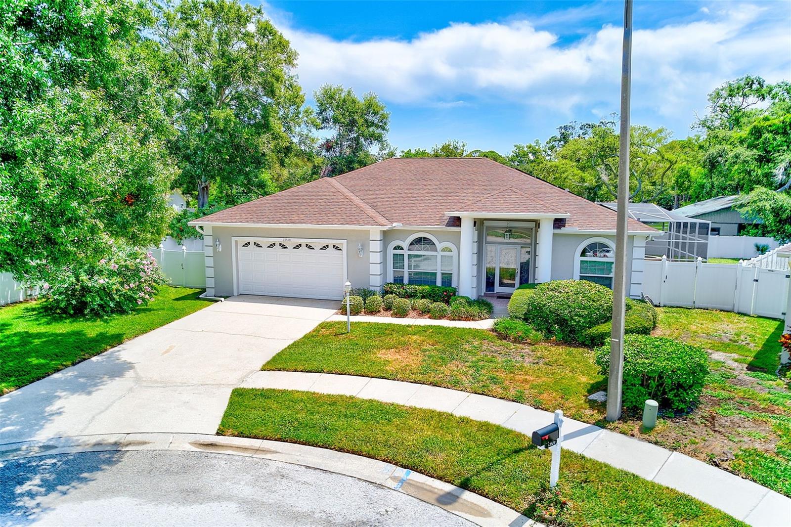 Welcome home to 13510 Oak Run Court, a beautifully maintained 3-bedroom, 3-bathroom home tucked away in a peaceful cul-de-sac street, just under two miles from the beach. Built in 1995 and located in a non-flood zone, this home blends modern comfort with coastal convenience and is perfect for those looking for space, flexibility, and peace of mind. Step inside to a bright, open living space where tall arched windows flood the living room with natural light. The home features a three-way split floor plan, offering privacy and versatility, including two primary suites, each with their own Jacuzzi tub and separate shower, making it ideal for multi-generational living or visiting guests. The kitchen is both stylish and functional, with stainless steel appliances, quartz countertops, wood cabinetry, tile backsplash and an updated gas stove and convection oven. It flows effortlessly into the dining area and adjacent family room, where built-in bookshelves and a wood-burning fireplace add charm and warmth. A dedicated office/den provides the perfect work-from-home setup or could serve as a fourth bedroom if needed. The interior laundry room offers additional convenience and tucked in pantry space. This home offers peace of mind and energy efficiency with full solar power (no batteries), a whole-house Generac gas generator, and hurricane-impact windows and/or shutters. A buried 250-gallon propane tank fuels the pool heater, stove, and oven, and there’s also a plug-in connection for an additional backup generator. The property features a six-zone irrigation system installed in 2022, along with several recent upgrades, including a new AC unit (2021), water softener system (2021), saltwater generator (2020), hot water heater (2020), and a roof replacement completed in 2015. If you’ve been searching for a newer-built home in a quiet, well-kept neighborhood close to the Gulf, this is a rare opportunity. Schedule your showing today and experience all that this home has to offer!