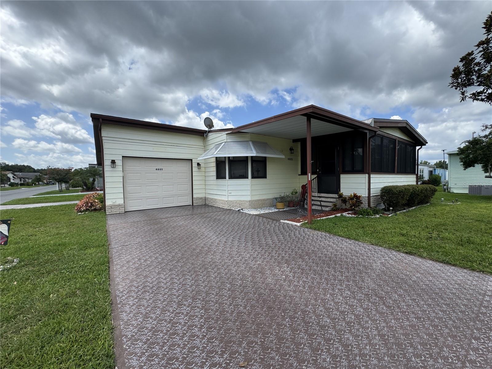 Spacious Corner Lot Home with Great Potential in a 55+ Community! Located in a desirable area, this 2-bedroom, 2-bathroom home sits on a prime corner lot and offers generous space both inside and out. The oversized lanai is perfect for relaxing and watching the activity within the community. Enjoy plenty of parking with two separate driveways—one featuring a carport that fits two cars end-to-end, and the other leading to a one-car garage. Inside, the large kitchen offers ample room for cooking and entertaining, complete with a formal dining area. The primary bedroom includes an ensuite bathroom and abundant closet space. Laundry is conveniently located in the shed, helping keep the interior cool when the dryer is in use. Some appliances have been recently updated. With just a little TLC, this home could shine once again—an ideal opportunity for the savvy buyer. The seller is motivated and ready to move on to the next chapter of her life. Don’t miss out on this one!