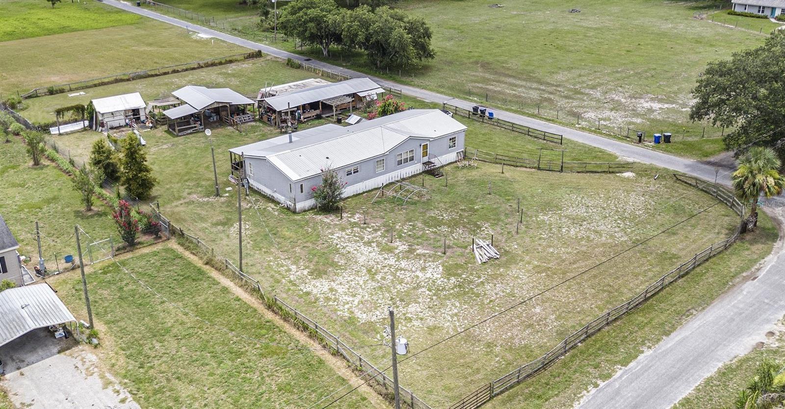 Welcome to your serene retreat nestled on nearly 1 acre of expansive property! This charming 3-bedroom, 3-bathroom manufactured home also features a dedicated office that could easily serve as a fourth bedroom—offering the perfect blend of comfort and outdoor paradise. Inside, you'll find a spacious layout with all bedrooms featuring walk-in closets—providing ample storage and personal space for everyone in the household.
The heart of the home is a warm and inviting farmhouse kitchen, featuring plenty of cabinet space, custom countertops, a stylish backsplash, a large island perfect for meal prep or casual dining, and a farmhouse sink that adds charm and functionality.
Step outside to discover a large pole barn with 4 stalls—ideal for housing horses, goats, or other animals, or for use as extra storage or a workshop. The detached covered entertainment patio is perfect for hosting outdoor gatherings, movie nights, or simply relaxing while watching stunning sunsets.
Additional highlights include two powered storage sheds—great for tools, equipment, or creative projects. You'll also find a chicken coop in good shape and ready for your feathered friends, nestled beside a cozy duck den for your waddling companions. Just a bit of TLC and both will be ready to go!
Whether you're dreaming of hobby farming, entertaining under the stars, or enjoying the peace and privacy of country living, this property offers endless possibilities. Don’t miss your chance to turn this versatile space into your perfect home!