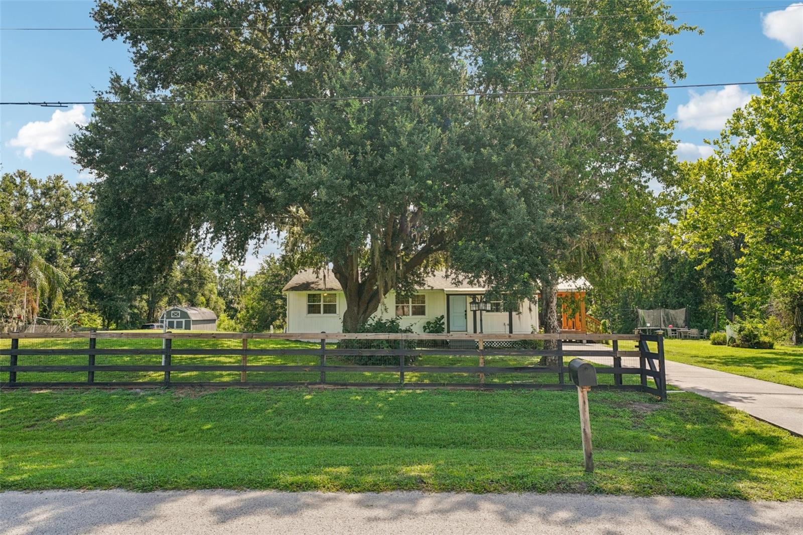 One or more photo(s) has been virtually staged. Charming Farmhouse-Style Home on an Acre in Wesley Chapel!
Tucked away on just over an acre, this 3-bedroom home offers a peaceful setting with the perfect mix of charm and practicality. Inside, you'll find a thoughtfully updated interior with a farmhouse-inspired feel—freshly renovated between 2021–2022, including a new kitchen and bath, updated flooring, hurricane-rated windows, and fresh paint inside and out. All appliances will convey, including a washer and dryer.
The home features a 12x28 screened front and open air side porches that are ideal for lazy mornings or evening chats. Outside, there’s plenty of room to roam, garden, play, or just enjoy the space—plus a 12x24 shed, and a fenced and electronically gated yard for added peace of mind.
No HOA to worry about, great neighbors all around, and plenty of parking. Right across the street from Double Branch Elementary School for convenience. If you're looking for something move-in ready, practical, and tucked into a beautiful piece of Florida land—this just might be the one.