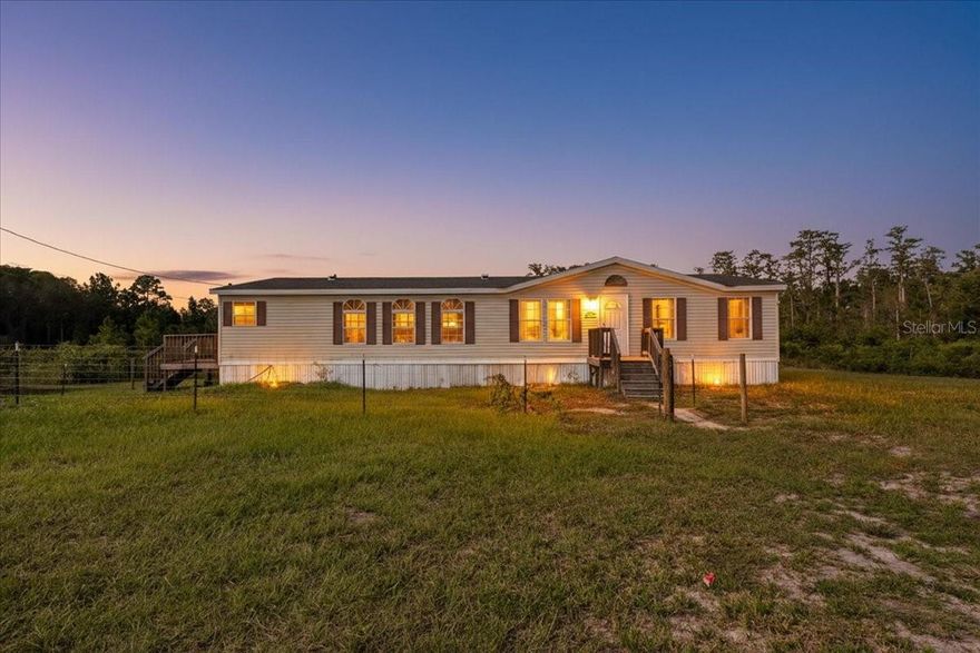 Motivated Seller! Wow! What a location yall... perfect 1999 DWMH located on 10.57 acres right off Addy Jones road . Just between Trenton and Newberry Florida . This property is nice and secluded with a mixture of wetlands and dry lands offering the perfect piece to see plenty of wildlife. This 3 bedroom /2 bathroom home offers a beautiful bright open floor plan. As you enter the home you will see a nice oversized living room area. There is space for a dining room table as well. Master bedroom is off the right side of the living room and is very large with a huge walk in closet, master bathroom with a stand up shower, soak tub and dual sinks. Kitchen offers plenty of cabinetry and a built in pantry. Entry to the guest hallway with guest bathroom and each guest bedroom on each side. There is a nice laundry room very spacious with an exit door on the side. This home is ready and waiting for your personal touch to make it yours and if you are in need of an easy commute to Gainesville or surrounding Alachua counties BUT want to enjoy low property taxes this place is for YOU! Located a short drive to several local freshwater springs and The Suwannee River as well. Accepting Cash and Conventional loans only, call today for YOUR tour.