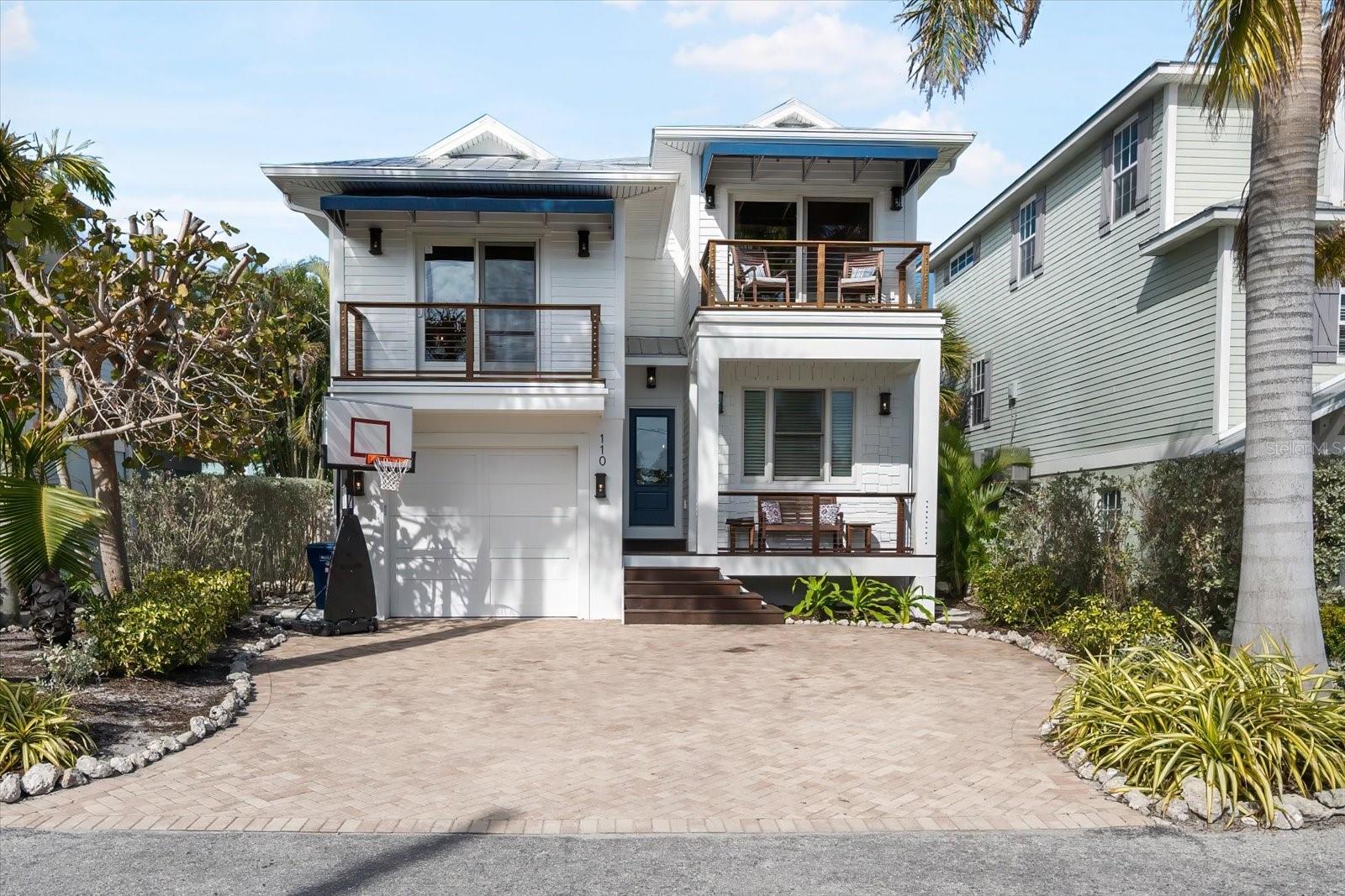 This is the one! Your dream beachside retreat on Anna Maria Island awaits. This stunning 4-bedroom, 4-bath, 1- car garage home offers the perfect blend of luxury, comfort, and coastal living. Just steps away from the pristine shores of the Gulf, this residence is truly an oasis of coastal charm. Walk up the stairs to your large covered porch then step inside to be greeted by a bright and airy open living area. Designer touches include vaulted ceilings, coastal-inspired furnishings, custom cabinetry and strand woven bamboo flooring. The cottage feel carries into the kitchen with glass front custom wood cabinets, a new gas range, ice maker and a large quartz countertop island that doubles as a breakfast bar. The split level floor plan gives ample privacy for you and your guest with the primary suite on the top floor including a large en-suite with soaking tub, separate shower and a private balcony. 3 additional bedrooms are equally well appointed with adjoining bathrooms. The backyard is ideal for entertaining and cooling off pool side after a long afternoon on the beach. This home is elevated and suffered no storm damage from hurricanes! Centrally located on a quiet beach access street, it is the perfect home base to enjoy Anna Maria Island's vibrant community, charming shops and restaurants and the blue waters of the Gulf just steps away. Don't miss your opportunity to own this fantastic Investment Property!