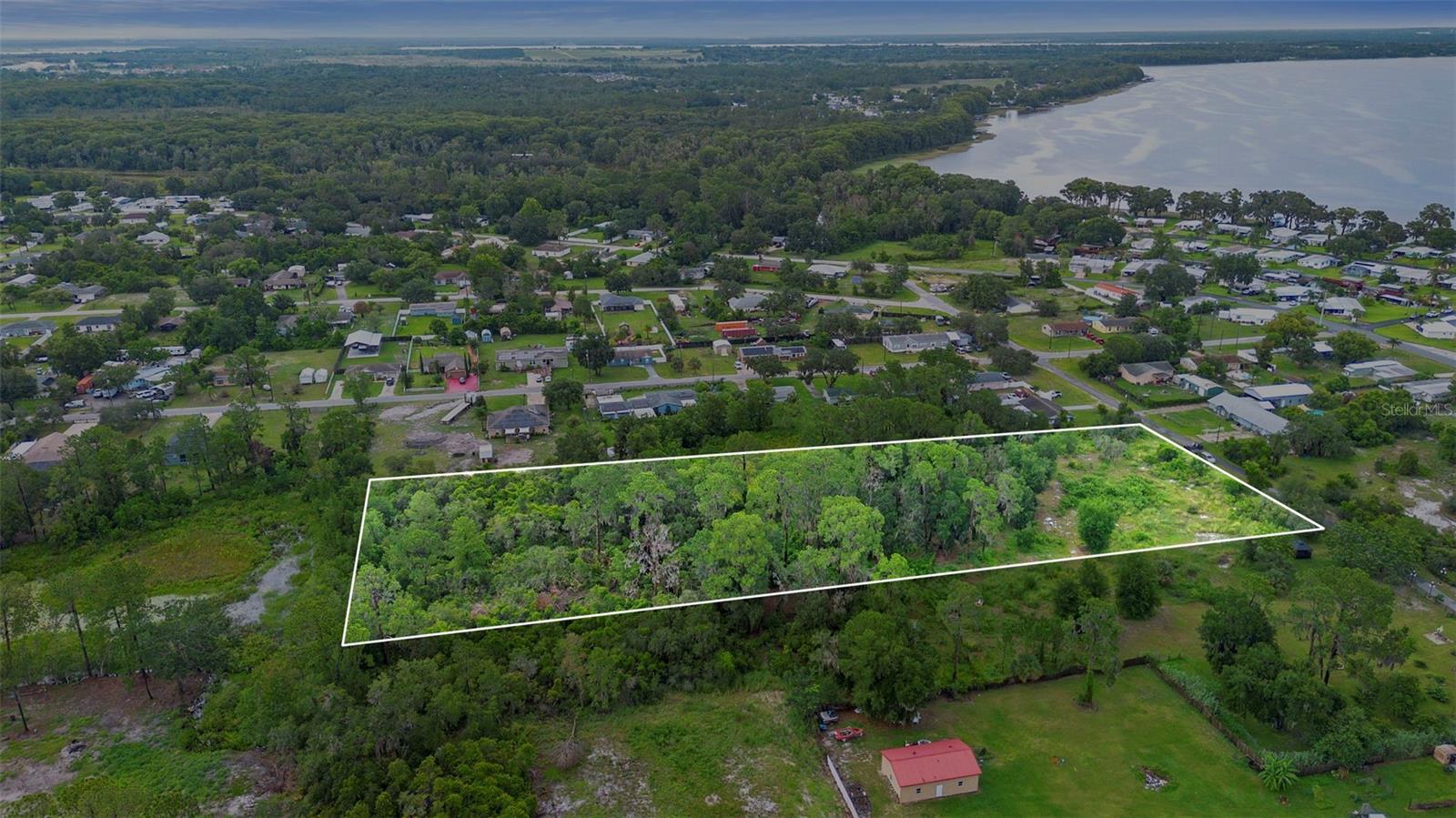 Over 3 Acres of Possibility – Prime Location!
Opportunity awaits on this gorgeous 3.08-acre (200 ft x 700 ft) parcel nestled in a quiet, well-established neighborhood. With mature trees offering shade and privacy, this property is the perfect canvas to build your dream home, place a manufactured home, or even create a private getaway surrounded by nature.
Enjoy the freedom of no HOA and plenty of space for outbuildings, recreational vehicles, gardens, or a custom-designed residence. The lot is high and dry, and while it will require a well and septic tank, utilities are nearby for a smooth build process.
Location is everything, and this property has it all—conveniently close to Lake Square Mall, Eustis, Tavares, Leesburg, The Villages, and the historic town of Mount Dora. You’ll love the nearby access to public transportation and all the shopping, dining, and entertainment these communities have to offer.
Outdoor enthusiasts will appreciate the nearby lake access. Whether you’re looking to build now or invest in land for the future, this one checks all the boxes. Don’t miss your chance to own over 3 acres in a desirable and growing area!