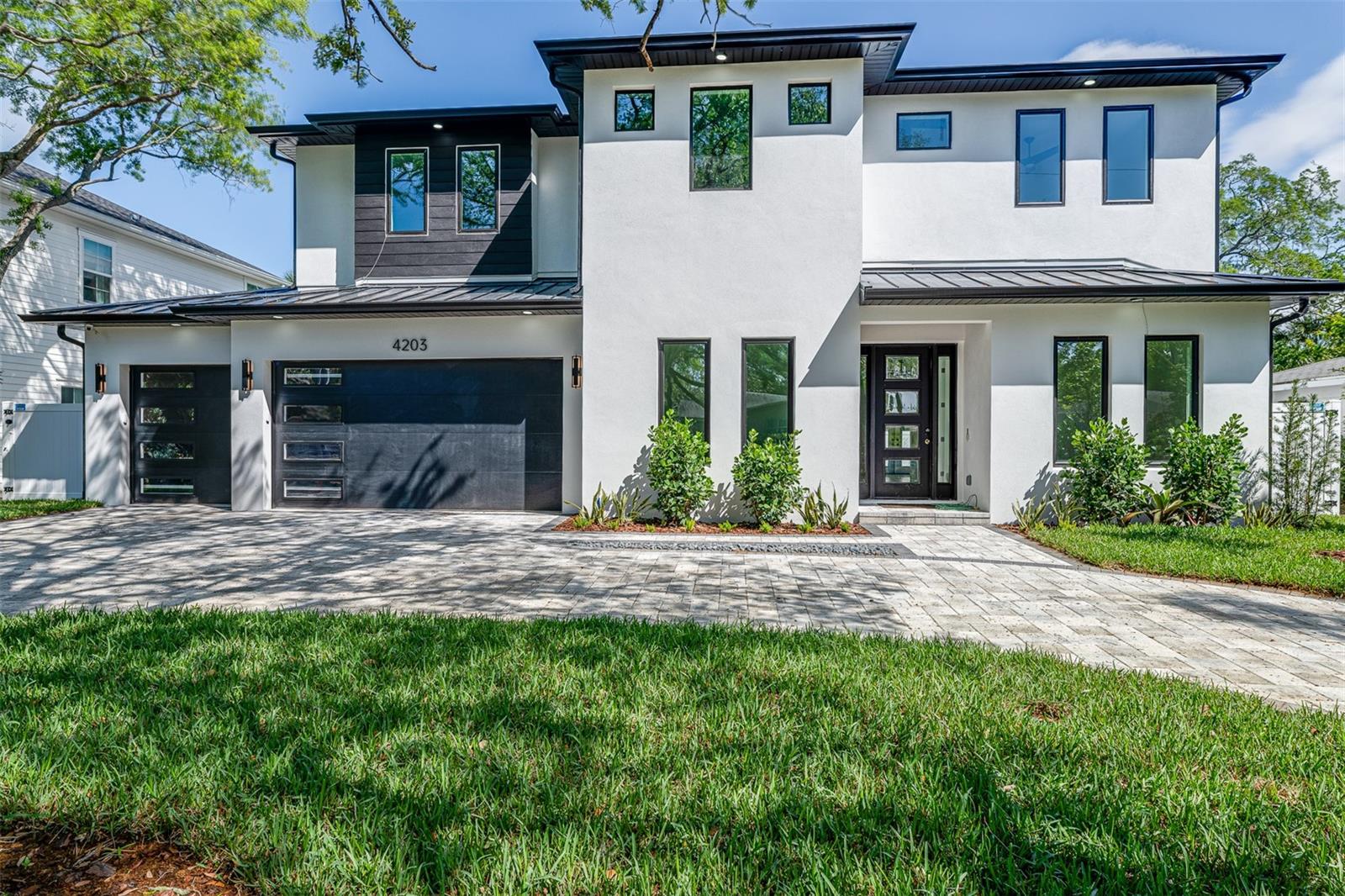Under Construction. Looking for a new construction home but don’t want to wait 12 months to move in? Take a look at this beautiful executive pool home NOW READY FOR MOVE IN, certificate of occupancy has been received! Rated for A+ schools including Mabry, Coleman, and Plant. This gorgeous contemporary home of 4,229sf offers 5 bedrooms, 4 full and 1 half bathrooms, formal dining room and study on a large 75x100 lot. You will be impressed with the features of this new build offering block construction on both the first and second floor, Low E Impact windows, and paver driveway/patio/porch. The open floorplan is perfect for entertaining with a grand living room space featuring a 7’ linear gas fireplace. Kitchen offers custom wood cabinetry with soft close doors/drawers, Thermador Appliance package with 36” gas cooktop, fridge, freezer, and wine tower columns, double wall oven, microwave drawer and dishwasher. Enjoy your Quartz counters with waterfall island and backsplash, large enough to entertain even the largest of gatherings. Spacious walk-in pantry and mud room add to the upscale convenience. Designer selected light and plumbing fixtures, 7.5” plank European white oak wood flooring throughout and stylish porcelain tiles in the wet areas. You will love your large master bedroom with walk-in closets and en-suite with dual vanities, freestanding tub, and frameless glass enclosed shower. The home also features a second master bedroom and bathroom filled with complete luxury. Three additional bedrooms complete the second floor along with an oversized laundry room. This home is in the gorgeous Virginia Park, a wonderful neighborhood perfect for walking and biking.