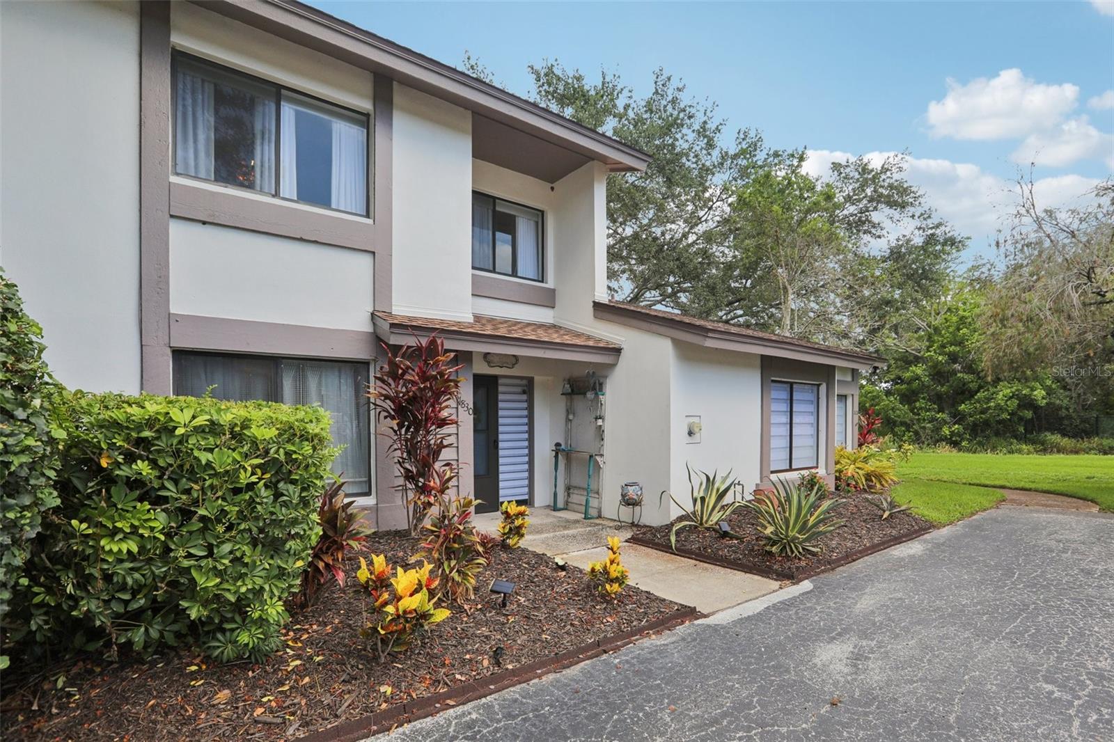 This beautifully updated 1,415 square foot, 2-bedroom, 2-bathroom + loft townhome in the highly sought-after Safety Harbor is the perfect place to call home! It boasts a modern kitchen, wood cabinets, stunning countertops with a breakfast bar, sleek stainless steel appliances, a brushed steel backsplash, and beautiful lighting. The first floor features a spacious bedroom, dining area, and a large living room with soaring ceilings, a wood-burning fireplace, and expansive windows that let in plenty of natural light. Upstairs, you'll find a spacious loft/office area that overlooks the living room, offering a great spot for work or relaxation. The grand master suite is 20 feet long and includes an updated bathroom with a large walk-in shower, neutral tile, and solid wood cabinetry. It also has a generous walk-in closet. Enjoy peaceful outdoor living on the large screened lanai, overlooking the back yard, along with tile flooring. The HOA covers a variety of services including building insurance, exterior maintenance, roof, painting, water/sewer, garbage, lawn care, basic cable, internet, exterior pest control, community pool, cabana, and hot tub. Plus, it's located in an X flood zone, offering extra peace of mind! This townhome combines style, comfort, and convenience, all in one fantastic location!