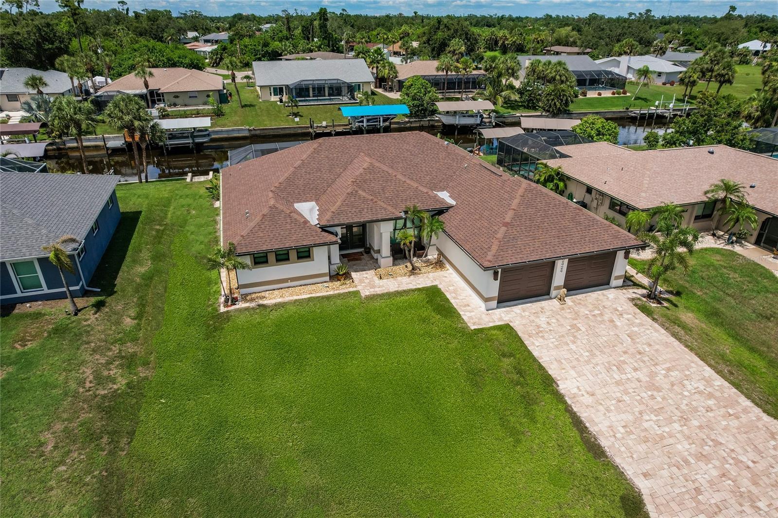 Experience luxury waterfront living in this better-than-new 2022-built 3-bedroom, 3-bath home in Port Charlotte, offering over 2,000 sq ft of air-conditioned space and direct Gulf access just minutes from Charlotte Harbor. Designed for comfort and elegance, the home features porcelain tile throughout, crown molding, coffered ceilings, two fireplaces, and hurricane-impact windows and doors. The chef’s kitchen boasts granite countertops, stainless steel appliances, and abundant cabinetry, while the primary and second bedrooms each include ensuite baths. Step outside to enjoy a private pool and spa, a concrete seawall, upgraded landscaping with lighting, and a brick paver driveway leading to an oversized 2-car garage. Located in an X flood zone where most lenders don’t require flood insurance, this home is also centrally positioned near beaches, shopping, and dining—offering the ultimate Florida lifestyle with no need to wait on new construction.