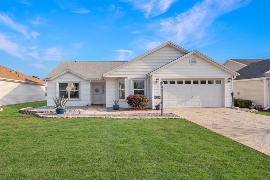 Beautifully maintained 3-bedroom, 2-bath home located in The Villages of Marion, offering a desirable blend of upgrades, functionality, and outdoor living with the bond paid in full. The home features an open split floor plan with tile flooring throughout the main living areas, custom cabinetry, and numerous thoughtful upgrades. The kitchen is well appointed with quartz countertops, subway tile backsplash, stainless Whirlpool appliances, gas range and microwave, and an oversized stainless sink, flowing into a combined dining and living area ideal for entertaining and connecting to the enclosed Florida Room and screened patio. The spacious primary suite includes a custom walk-in closet with wood closet system and an ensuite bathroom with dual vanities and a glass-enclosed walk-in shower. Additional highlights include a laundry room with utility sink, custom paver driveway, epoxy-finished garage floor, and a Hunter irrigation system. Ideally situated near multiple executive golf courses, and also close to Nancy Lopez Country Club and the Mulberry Grove Regional Recreation Center, with convenient access to shopping, dining, and everyday conveniences along US-441/27, the property also includes a 2015 Yamaha gas-powered two-seat golf cart with approximately 484 hours, allowing for immediate enjoyment of The Villages lifestyle.