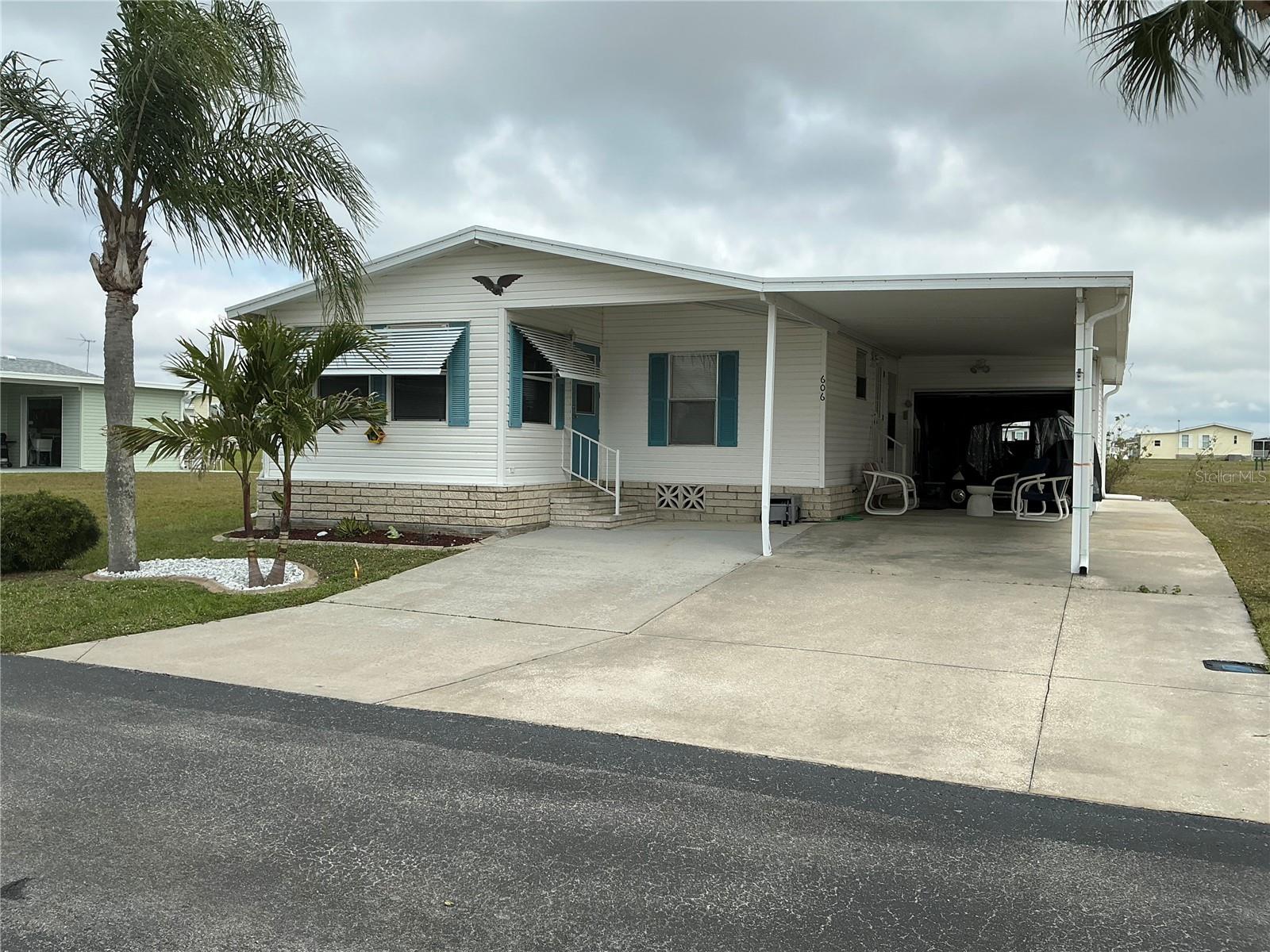 ******************************** PRICE REDUCED!!!**********************************
Charming home in a desirable 55+, gated community nestled in Central Florida. This well-maintained home, including a brand-new roof, comes fully furnished, right down to the dishes. There's a finished lanai which is currently being utilized as an office. Main bedroom has an ensuite, and the laundry is located in the house. Two-car carport with sunshades which provides a nice outdoor sitting area, large golf cart shed to shelter the golf cart which comes with the house, as well as plenty of room for a work area. Enjoy a peaceful and secure lifestyle with nicely maintained common areas, fantastic amenities such as pool, hot tub, pickle/tennis courts, shuffleboard, cornhole court, bocci ball, billiards room and library. There's all kind of organized activities during the season such as dances, holiday meals, craft show and lots of cards. We also have a 9-hole executive golf course, privately owned so there's a separate fee. One of the best things, you own your land, so no rental fees. The current association fee is $206 per month which includes your lawn being mowed & trimmed, basic cable, internet and the removal of garbage for the park. Great place to have the retirement you have always dreamed of, so bring your sunglasses and join in the fun where you won't be a stranger for long!