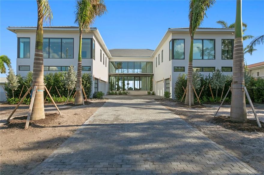 Move-in Ready and furnished, like NO other, spectacular Snell Isle waterfront estate is a modern expression of art and design. This 8,773 sqft. modern masterpiece showcases clean lines and walls of glass that open to resort-style indoor/outdoor living spaces overlooking sparkling Tampa Bay. One-of-a-kind gated estate showcases masterful craftsmanship and exceptional amenities with soaring 22-foot ceilings in the great room, floor-to-ceiling windows, gallery walls, and abundant natural light. The open-plan dining and living areas are perfect for stylish entertaining with a chef’s kitchen, custom cabinetry, stone countertops, Subzero, True and Wolf appliances and a walk-in wine room. Hurricane impact windows and doors open to the resort-style backyard with spacious patios, outdoor kitchen, pool, spa, shower, a new private dock and 24,000lbs boatlift overlooking Tampa Bay. The main level features a master suite with water views, a spa bath, 2 water closets and an extravagant closet. The floating stairway leads upstairs to 4 bedrooms plus an in-law suite with a kitchenette, an office or 5th bedroom, an entertainment room complete with a large bar, theater, and a massive outdoor balcony with incredible water views of the St. Petersburg skyline, St. Petersburg Pier, and the Sunshine Skyway Bridge. The upper-level master suite features a resort-style bath, oversized walk-in closet and leads to the balcony. Additional features include an elevator, smart home tech, a whole house generator, exercise room with a sauna, a 6-car garage tall enough for car lifts, electric car charger, and a whole house water filtration system by One Green Filter complete with 4 reverse osmosis spickets for spot free windows and car washing. This distinctive custom estate is situated on coveted Brightwaters Blvd. NE, and is located moments away from vibrant downtown St. Petersburg, the St. Petersburg Pier, restaurants, and museums. The quality and attention to detail of this solid block construction estate is sure to impress the most discerning buyers.