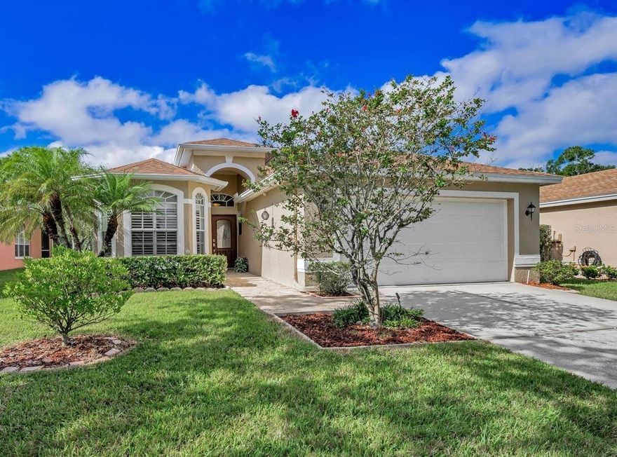 Looking for PRIVACY and STUNNING WATER VIEWS with NO FRONT OR REAR NEIGHBORS? Discover the perfect blend of Serenity and Comfort in this 3-Bedroom, 2-Bath home nestled in the much sought-after, GATED GOLF COMMUNITY OF EAST LAKE WOODLANDS. Enjoy BREATHTAKING LAKE VIEWS and a front row seat to scenic nature from your LARGE, SCREENED LANAI complete with Pavers and offering both Covered and Open Spaces—perfect for entertaining or relaxing with that morning cup of coffee or evening glass of wine. This home is located in Zone X500 which does NOT require Flood Insurance and the owner had no issues with the two hurricanes in 2024. Step inside to HIGH CEILINGS, LOADS OF NATURAL LIGHT and an OPEN GREAT ROOM PLAN with GORGEOUS HARDWOOD FLOORS throughout the Living Areas and Bedrooms with Tile in the Kitchen and Bathrooms - so NO CARPET! The bright and airy Great Room features Glass Sliders that pocket to provide SEAMLESS INDOOR, OUTDOOR LIVING. Spacious and Well Equipped, the Bright Kitchen features Ample Cabinetry and plenty of Counter Space with GLEAMING GRANITE, an ISLAND WITH BUILT-IN WINE RACK and generous EAT-IN SPACE for casual dining.  
With this Split Floor Plan, the SIZABLE PRIMARY SUITE affords Privacy and Tranquil Water Views with the security of a LARGE HURRICANE IMPACT REAR FACING WINDOW (2020). You’ll feel pampered with an EXPANSIVE WALK-IN CLOSET, VANITY WITH DOUBLE SINKS, LARGE SOAKING TUB and High End TOTO Toilet with Bidet feature. Both Secondary Bedrooms feature Built-In Closets for your storage needs with the third also providing Double Doors for the versatility of using as a guest room or den or office. A full 2-CAR GARAGE provides convenience and additional storage as well as the separate Laundry Room complete with Deep Tub Sink and compact WASHER AND DRYER included in the sale. Relax and Simplify your Life since the LOW HOA FEE TAKES CARE OF LAWN MAINTENANCE. Updates to the home include a NEW ROOF IN DEC. 2024 and NEW 3.5 TON A/C IN 2017. The PAVERED LANAI has Electrical Access – so perfect to add a Hot Tub to further enjoy that Spectacular View. Furniture is also negotiable. Plus enjoy a Wide Array of Amenities with ARDEA COUNTRY CLUB Optional Memberships for additional fees featuring 2 Golf Courses, Tennis and Pickle Ball, Fitness Center, Lap and Free Form Pools and a wide array of Dining and Social events. All this in a PREMIER LOCATION Convenient to TAMPA INTERNATIONAL AIRPORT, Medical Facilities, A-Rated Schools, Award-Winning Beaches as well as Professional Sporting Events, Concerts, Fine dining and more.