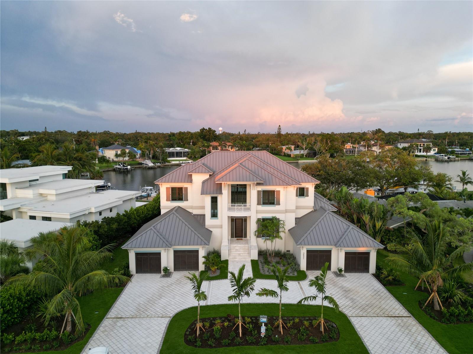 3621 San Remo is complete and ready for occupancy, come and experience the epitome of luxury! Minutes from Siesta Key and Miles from Ordinary! Nestled on a quiet cul-de-sac west of Orange Avenue, this Florida Coastal masterpiece by Seaward Homes offers over 5300 sq. ft. of prime waterfront living. With a bayou stretching almost 400 feet wide, enjoy direct access to the breathtaking Sarasota Bay and BIG WATER VIEWS that define coastal elegance.
Designed with meticulous attention to detail, the home features an expansive, light-filled open floor plan. It includes five spacious bedrooms, each with its own walk-in closet, five full baths, and two half baths. Two oversized lanais and a four-car garage ensure seamless indoor-outdoor living, while a third-level rooftop terrace provides panoramic views of Sarasota Bay.
Quality and craftsmanship are paramount in this Seaward Curated Collection home. Constructed with concrete block on both the first and second floors, ensures superior structural integrity. Inside, locally crafted custom solid wood cabinets and high end finishes complement the kitchen’s luxurious Quartzite surfaces, including a custom island, backsplash, and an additional scullery. The professional-grade Thermador™ appliance package features a 30" refrigerator, 24" freezer columns, an induction cooktop, double ovens, and two Cove™ dishwashers—perfect for culinary enthusiasts.
Every detail has been carefully considered, from solid brass Kohlerâ„¢ plumbing fixtures and one-piece comfort height toilets to flooring that include large format designer porcelain tile or European white oak hardwood. The interior trim package includes eight-foot solid doors, oversized baseboards and casings, coffered ceilings, and substantial crown molding, with ceiling heights reaching up to 12 feet in select areas.
Additional highlights include a state-of-the-art electrical and lighting control system, a high-efficiency multi-zone Traneâ„¢ air conditioning system, hurricane impact-rated insulated glass, and 10-foot sliding impact glass doors throughout. The architectural elegance of the home is further enhanced by a standing-seam metal roof, combining style and durability.
Outdoors, the expansive 45-foot wide lanai, complete with an outdoor kitchen and gas grill by Coyoteâ„¢, is perfect for entertaining, while the 40-foot inground, edgeless heated salt water pool and spa, designed by Borden Landscape Architects, offers a private retreat. The exterior is complemented by a semi-circular driveway with concrete shell pavers and an irrigation well.
Located at San Remo Terrace, this luxurious "West of Trail" property is just minutes from Siesta Key Beach, Morton’s Market in Southside Village, Downtown Sarasota, and Sarasota Memorial Hospital, making it the ideal home for those seeking the ultimate Florida lifestyle.