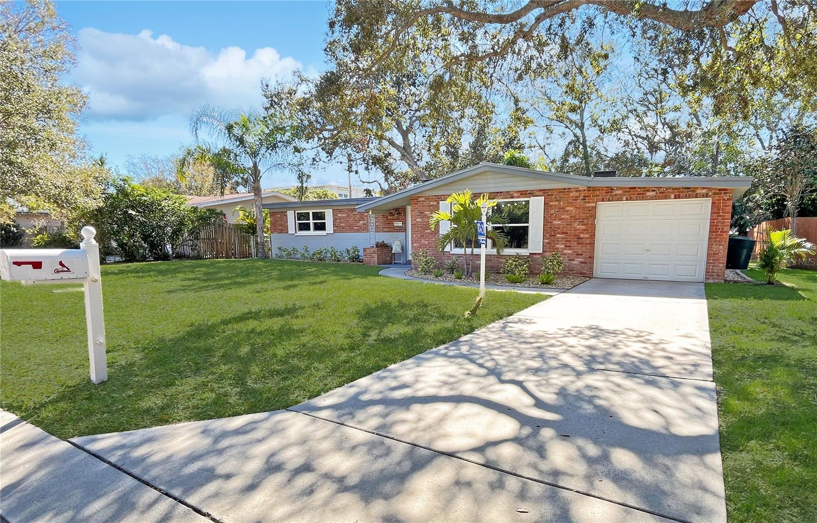 One or more photo(s) has been virtually staged. HURRICANE SEASON IS HERE! Choose "SAFE" in this "high and dry", non-evacuation, no storm surge neighborhood. Choose "SECURITY" with a home with a new roof (coming soon) and a 13-month home warranty for peace of mind. Don't worry, be happy, chilling and grilling in the backyard you have been dreaming of. Step inside and imagine this move-in-ready beauty as your very own. The living room has a striking brick focal wall which exudes mid-century modern elegance. The stylish kitchen is outfitted with shaker cabinets and gleaming newer stainless-steel appliances. Adjacent is a separate dining room AND a versatile family room offering endless possibilities for entertaining or personal projects. The primary bedroom is remarkably spacious with a walk-in closet for your shorts, tees and flip-flops. Take note of the new and newer elements like a tastefully renovated bathroom, hurricane-rated garage door, and even hurricane-rated windows (with the exception of one). The contemporary lighting fixtures, new door hardware, fresh Sherwin Williams paint coupled with neutral luxury plank vinyl flooring, perfects the look and feel of the home. And yes, there is room to add a half bath or another full bath to the home. Now, back to the backyard! A true sanctuary - private, fenced, and perfect for relaxation at any time of day. It will be easy to picture yourself grilling with a cold beverage in your hand. The Pleasant Grove neighborhood is a hidden gem, teeming with friendly neighbors and tranquility, yet conveniently close to all the charms of Dunedin. Whether you prefer walking, biking, or CRUISING IN YOUR GOLF CART, you’re just moments away from shopping, restaurants, and entertainment. Don’t miss out on claiming your spot in Dunedin! Make an appointment to see this home today!