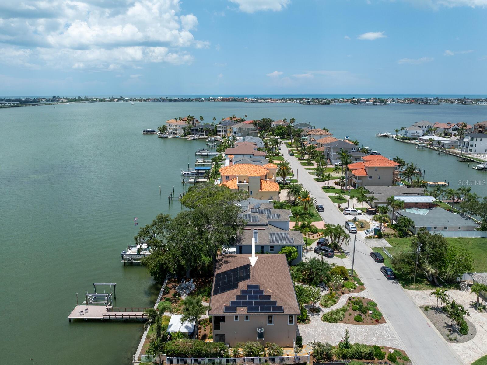 Completed in 2019, this exquisite custom-built home offers the best of Belleair waterfront living with breathtaking southern-facing open water views of the Intracoastal Waterway and the Belleair Causeway. Designed for elevated living and efficiency, this residence blends waterfront luxury with smart upgrades and unmatched views. A residential elevator provides easy access to the main level, where sunlight fills the open-concept living space featuring 9-foot ceilings, crown molding, porcelain tile and motorized window treatments throughout. High-impact windows and doors ensure peace of mind and energy efficiency, while whole-home NAD Blue Sound and KEF audio systems deliver immersive sound indoors and out. This home is powered by solar panels with three Power Walls for whole-home battery backup. The chef's kitchen is a showstopper with Blue Bahia granite countertops and backsplash, an oversized center island, custom cabinetry with built-ins and rollouts, and top-of-the-line appliances including a KitchenAid counter-depth refrigerator, Electrolux five-burner cooktop, built-in Frigidaire Professional convection oven and microwave, and a 120-bottle wine cooler. A motorized electric trash chute also adds convenience to this space. The expansive 63-foot Trex balcony deck is ideal for entertaining or relaxing with its built-in Red Lion five-burner gas grill and motorized SunSetter awnings. King-sized primary suite offers sweeping water views, a large custom walk-in closet and a luxurious spa-style bath with soaking tub, oversized walk-in shower, double vanities, and a private commode room with automated Toto. The second spacious bedroom features a custom closet with abundant storage, an upscale en-suite bath featuring a separate soaking tub, walk-in shower, double vanities and a private commode room with Toto, providing comfort and privacy for guests. The well-appointed study is ideal as a home office or potential third bedroom. Full-size laundry room is conveniently off the main hall with custom granite and cabinetry. Downstairs, you’ll find two flexible bonus rooms with sliding doors to the backyard. This space is ideal for entertaining, game room, media room, gym or additional home office. The extra deep 18-by-33-foot wo-stall garage includes epoxy floors (2025), ample storage, and can easily accommodate a golf cart or recreational gear. Outside you’ll find new lush 2025 Florida native landscaping and expansive patios. Your private composite dock, built in 2019 with all new wrapped pilings and seawall, includes a remote-controlled 13,000-pound boat lift, dock lighting and a Tempest weather station. Additional upgrades include a commercial water heater (2025), water softener, electronic HVAC filter system, LED lighting and more. In the quaint Town of Belleair with its police department, recreation center and town hall. Close to Gulf beaches, excellent medical facilities, banking, shopping and dining. A golfer's paradise with Belleair Country Club and Pelican Golf Club. TPA 40 minutes & PIE 30 minutes. This is waterfront living at its finest, blending high-end finishes, smart technology and Florida charm, all with incredible open water views, just bring your boat! The feature sheet attached with all the bells and whistles. Floor plan photos 69 and 70. Must see Vimeo: https://vimeo.com/1097082065