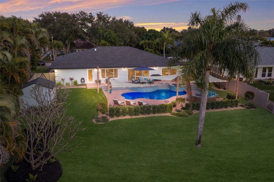 FULLY RENOVATED ELEVATED WATERFRONT RETREAT WITH GULF ACCESS, POOL & BOAT LIFT! Waterfront living meets elevated peace of mind in this fully renovated 4 bedroom pool home on desirable Belair Bayou. Perfectly positioned on a rare elevated bluff and NOT located in a flood zone, this property offers the best of Florida waterfront living with added security, protection, and long term value...an increasingly rare combination. Completely reimagined by Cahill Homes in 2024, the home showcases nearly 3,000 square feet of thoughtfully designed living space with a bright, open floor plan, vaulted ceilings, designer lighting, recessed lighting, and walls of sliding glass doors that seamlessly connect indoor and outdoor living. The kitchen is a true showpiece, designed for both everyday living and entertaining, featuring custom wood cabinetry with contrasting lower cabinets, oil rubbed bronze hardware, granite countertops, an oversized island with seating, workstation sink, herringbone backsplash, under cabinet lighting, glass-front display cabinetry, and premium stainless steel appliances including a French door oven and 6 burner Fulgor gas range with statement hood. A spacious walk-in pantry completes this well designed space. The primary suite offers a private retreat with tray ceilings, updated lighting, and ample room for a king sized bed and sitting area. The ensuite bath features dual vanities with granite countertops, custom cabinetry, designer fixtures, and a large walk-in shower with glass enclosure, along with two walk in closets providing abundant storage. On the opposite side of the home, two additional bedrooms and a fully renovated bathroom provide comfort and privacy for guests and also function as a convenient pool bath. The fourth bedroom, currently used as an office, easily serves as a bedroom with an existing closet. A well appointed laundry room includes custom cabinetry, granite counters, an undermount sink, and tile backsplash with under-cabinet lighting. Step outside to a private tropical setting designed for relaxation and entertaining, featuring a heated pool and elevated spa surrounded by paver decking, lush professional landscaping, sail shades, string lighting, and multiple seating areas. The fully fenced yard offers generous green space, water views, and a custom storage shed. The property extends to a private 50+ foot dock with a covered boat lift on Belair Bayou, providing direct access to Warner’s Bayou, the Manatee River, and the Gulf - ideal for boating, fishing, and true waterfront living. This protected waterway is known for high bridge clearance and easy navigation for larger boats. Extensive upgrades include a NEW ROOF, IMPACT WINDOWS AND DOORS, NEW HVAC & DUCTWORK, NEW TANKLESS WATER HEATER, RENOVATED POOL AND EQUIPMENT, NEW FENCING, NEW IRRIGATION, PROFESSIONAL LANDSCAPING, NEW STORAGE SHED, AND MORE - offering a completely move-in ready experience. The home also impresses with an expansive circular paved driveway, mature tropical landscaping, coastal-inspired exterior, modern lighting, double door entry, and a two-car garage, creating standout curb appeal. Conveniently located minutes from Anna Maria Island beaches and a short drive to St. Petersburg and Sarasota, with easy access to IMG Academy, St. Stephen’s Episcopal School, Bradenton Christian School, and Robinson Preserve. A rare opportunity to own a fully updated, elevated waterfront home with direct Gulf access in NW Bradenton!!!