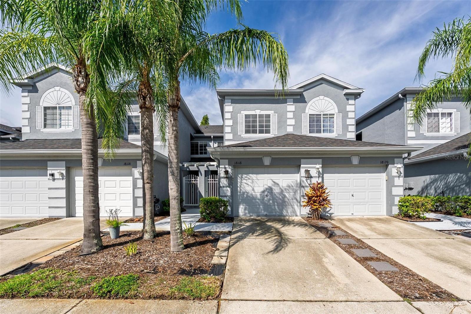 Experience refined comfort and unbeatable value in this beautifully maintained 3-bedroom, 2.5-bath townhome with 1-car garage, ideally located in the resort-style, gated golf community of Heritage Isles. Backing to a peaceful conservation area—no rear neighbors—this home offers over 2,000 square feet of thoughtfully designed living space. The open-concept main floor features upgraded ceramic plank tile flooring throughout, creating a stylish yet durable foundation that flows seamlessly from the foyer into the spacious living and dining areas. The kitchen offers ample cabinetry, a pass-through breakfast bar, closet pantry, and eat-in area—ideal for casual dining or entertaining. Step through sliding glass doors to your screened-in lanai with a storage closet and tranquil views of the preserve. Upstairs, enjoy luxury vinyl flooring throughout (excluding the laundry room with ceramic tile), and a generous owner’s suite complete with dual sinks, a garden tub, separate shower, and walk-in closet. Two additional bedrooms and a full guest bath complete the second level, along with a conveniently located laundry room. Heritage Isles offers an unbeatable lifestyle with an 18-hole championship golf course, resort-style pools with waterslide, tennis and basketball courts, playground, new fitness center, clubhouse, and an on-site restaurant with tiki bar. Just minutes to I-75, USF, Wiregrass Mall, Tampa Premium Outlets, and miles of hiking or kayaking at nearby Flatwoods Park or the Hillsborough River. Whether you're buying your first home, upgrading, or investing, this one checks all the boxes—schedule your private showing today!