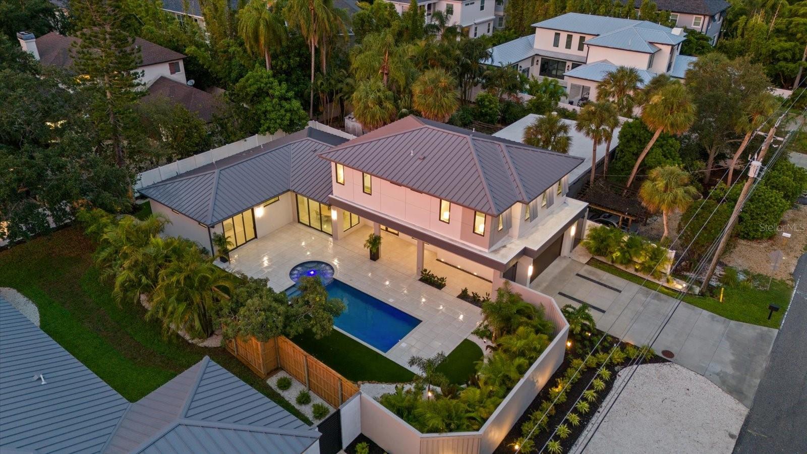 New Construction by Majestik Homes
Move-In Ready | Easy to Show
Welcome to 1559 Bay Road, a new home by Majestik Homes, ideally located West of the Trail in Sarasota’s coveted Granada neighborhood. Just 4.6 miles from Siesta Beach, 6.0 miles from Lido Beach, and only 1.9 miles from Sarasota Memorial Hospital, this prime address places you near upscale restaurants, artisan deli markets, scenic trail parks, top-rated schools, and world-class amenities.
From the moment you pass through the entrance gate into the private courtyard, you’ll be awed by the palm springs inspired saltwater pool and spa. Designed for both elevated entertaining and effortless daily living, this home blends thoughtful design with high-end finishes.
At the heart of the home is a chef’s kitchen outfitted with Thermador appliances, including a professional-grade gas range, built-in refrigerator, double oven, microwave, dishwasher, and wine fridge. Custom cabinetry, premium countertops, and a dramatic waterfall island elevate the space with refined functionality.
The expansive great room, flooded with natural light, offers seamless flow from the kitchen to the living and dining areas. Oversized high end impact windows and sliding glass doors bring the outdoors in, creating an airy, inviting ambiance ideal for gatherings.
The first-floor primary suite is a private sanctuary featuring a spacious walk-in closet and a spa-inspired en-suite bath. With a soaking tub, walk-in shower, dual vanities, and designer fixtures, this retreat is designed for pure relaxation.
Upstairs, three generously sized bedrooms and beautifully appointed bathrooms provide comfort for family or guests. A versatile loft space offers endless possibilities—home office, media room, or fitness area.
Additional highlights include:
High ceilings and abundant natural light throughout
Custom cabinetry and luxury fixtures
Professionally landscaped grounds
Located near Southside Elementary, Sarasota Memorial, and local cultural attractions
Located on a quiet, tree-lined street in the highly desirable Granada neighborhood, 1559 Bay Road offers luxury, comfort, and convenience—all just minutes from the best Sarasota has to offer.