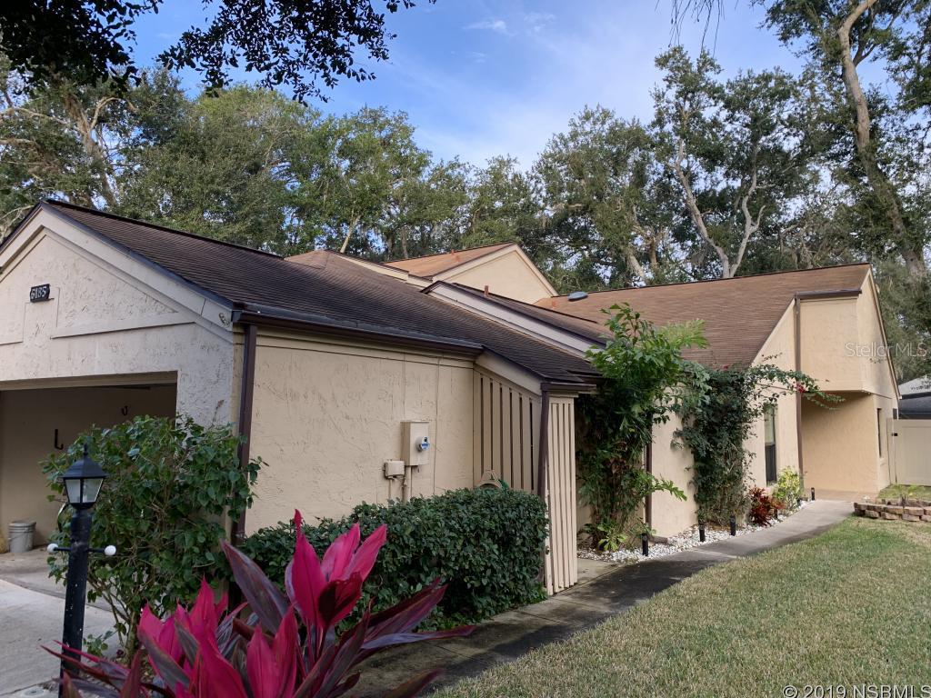 This is a beautiful 2 Bedroom, 2 Bath town home with a 2 car garage in desirable Port Orange area, waterfront community Riverwood Plantation! House is move in ready condition with beautiful wood laminate flooring, a master shower with large tile and glass shower doors. The open floor plan allows you to enjoy wood burning fireplace from the living room as well as the kitchen and dining areas. There is a breakfast bar, kitchen nook and formal dining room. There is a small private atrium of both bedrooms as well as a screened porch overlooking the back yard with french doors from the living room. The lawn is maintained and the exterior of the home is painted every 4-5 years. Renovations include washer and dryer, and newly installed windows.The community has a dock, a boat ramp to Spruce Creek, pool, basketball and tennis courts, playground and clubhouse. It's the perfect new home for YOU!