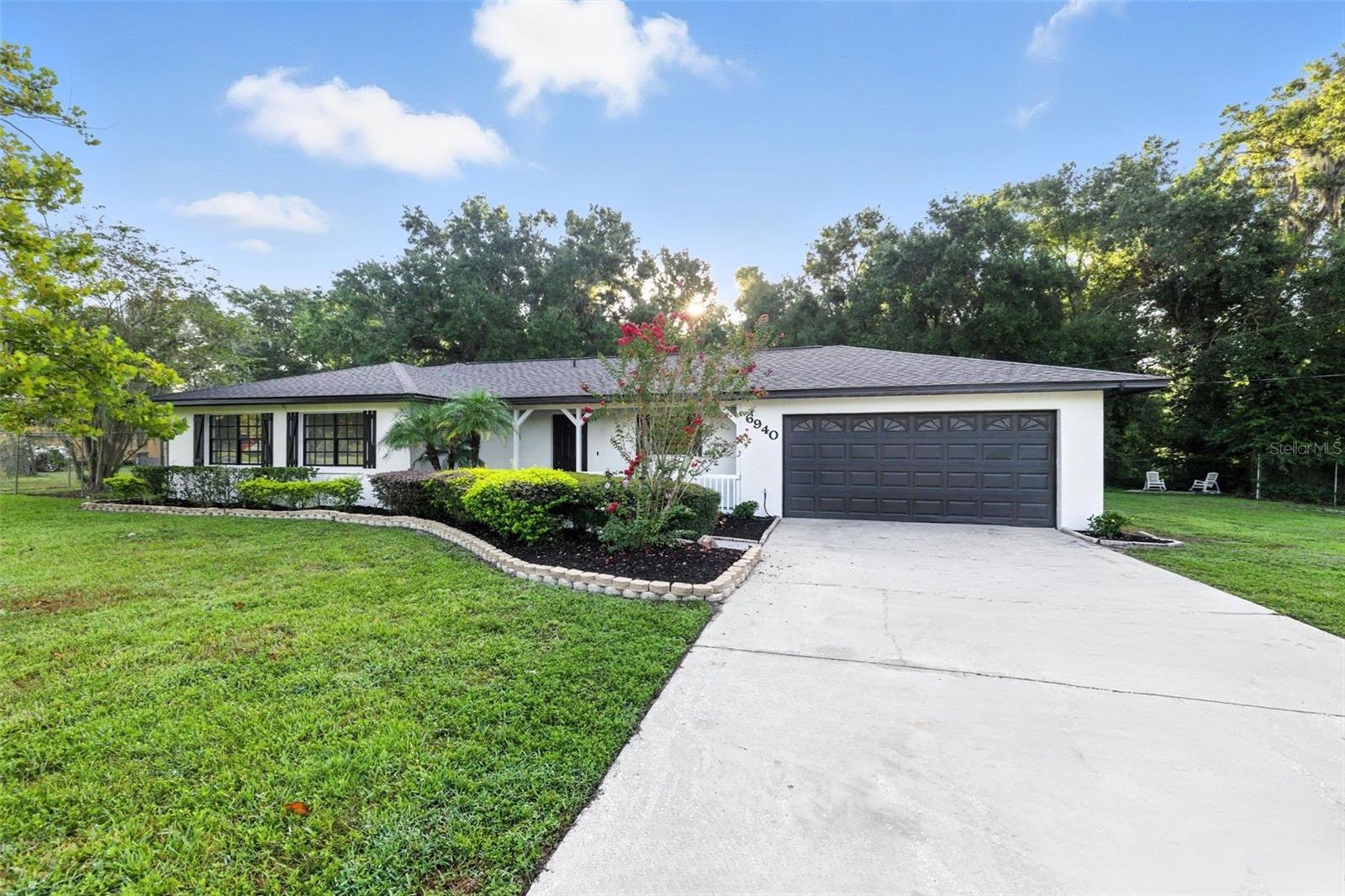 Updated from head to toe with no detail missed, this stunning South Lakeland located in a X FLOOD ZONE retreat offers the perfect blend of space, style, and freedom on a rare 0.75-acre corner lot with no HOA or CDD. Every inch of this 3-bedroom, 2-bathroom home has been thoughtfully renovated, featuring brand new major systems—including a NEW ROOF, NEW A/C, and NEW WATER HEATER —for ultimate peace of mind. Inside, the open-concept layout seamlessly connects the living and dining areas to a stunning chef’s kitchen designed for both comfort and entertaining. The kitchen is a standout with solid wood, dual-tone 42” soft-close cabinetry, quartz countertops that carry into a sleek full-height backsplash, premium stainless steel appliances, and a large island with breakfast bar seating. Additional upgrades throughout the home include luxury vinyl plank flooring, designer height baseboards, updated plumbing, completely updated bathrooms - vanities, tiling, flooring, and all-new hardware and fixtures—lighting, mirrors, and finishes all meticulously selected to reflect timeless style. Step outside to enjoy your fully fenced backyard oasis, complete with a covered patio and a spacious 12x20 utility shed—perfect for storage, hobbies, or entertaining. Whether it's an RV, boat, or extra vehicles, the generous outdoor fenced space offers the freedom and functionality rarely available in neighborhoods this desirable. The attached 2-car garage includes washer/dryer hookups and a new automatic opener for added convenience. Located in quiet and convenient South Lakeland, just minutes from shopping, dining, and top-rated schools, this home offers more than just a fresh start—it’s a fully upgraded lifestyle, ready for you to enjoy from day one.