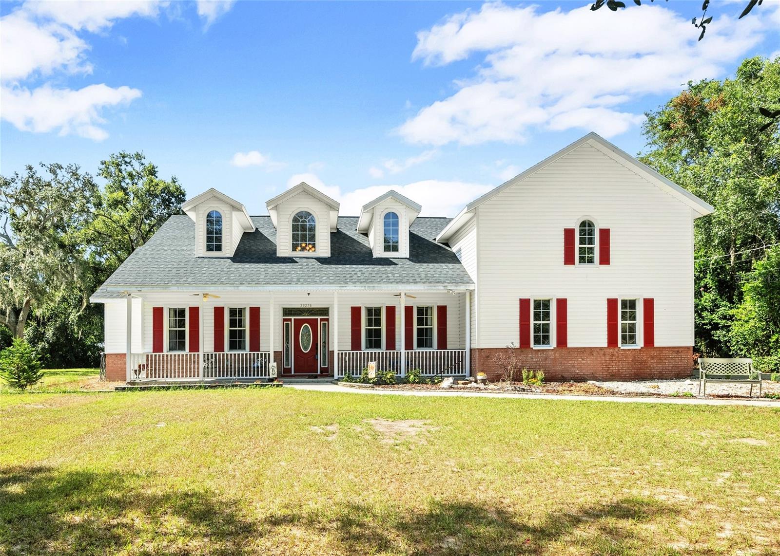 Escape to your own private retreat in this stunning 3-bedroom, 3-bath, w/ bonus room, split-level home located on a spacious 0.49-acre lot in the beautiful Ridge Manor area of Dade City, FL. The home has been completely updated from the brand new roof to new flooring throughout and everything in between with a sophisticated attention to detail. The entrance boasts a cathedral ceiling that flows seamlessly into the open-concept family room and kitchen, creating an airy and inviting atmosphere. Unwind by the cozy warmth of the stone wood-burning fireplace, gracing both the family room and kitchen. Then indulge yourself in the exquisitely designed master bath featuring dual sinks, a luxurious tub, and a spacious walk-in shower with dual shower heads. Upstairs is a huge media room wired for sound and ready for family movie or game nights. Out back you'll find a large fenced backyard with detached workshop perfect for all your hobbies. Additional features include a two-car attached garage with room for the toys. This 2006-built home, featuring brick and vinyl siding, offers the perfect blend of elegance and comfort.