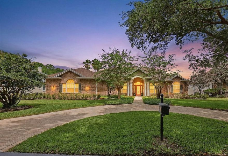 AN EXCEPTIONAL OPPORTUNITY to experience true lakefront living! Tucked away on a private road, this stunning red brick Colonial offers a lifestyle centered around privacy, outdoor living, and effortless comfort. With 4 bedrooms and 4 bathrooms, this home is designed for both everyday living and unforgettable entertaining. From the moment you step through the leaded glass entry into the grand columned foyer, the home opens into inviting spaces including a dedicated office, a formal dining room, and expansive living areas that flow seamlessly throughout. The family room features a beautiful fireplace, creating a warm and inviting atmosphere, while the kitchen is well-appointed with granite countertops and generous space to gather. An oversized laundry room adds everyday convenience, and thoughtful updates throughout the home include a generator installed in 2023, water filtration and softener systems updated in 2025 and 2026, a garage mini-split AC added in 2021, and updated pool pump and controls in 2019. Step outside and experience where this home truly shines. The private screened pool and spa create a perfect setting for both relaxing and entertaining, complemented by a covered outdoor kitchen and grilling area designed for year-round enjoyment. Beyond the pool, the property opens to a serene lakefront backdrop, where your private dock with a charming thatched tiki hut invites you to unwind, host guests, or take in stunning sunset views over the water. With dedicated space for paddleboards and outdoor gear, enjoying the lake becomes part of your everyday lifestyle. This home delivers a rare combination of privacy, functionality, and resort-style lakefront living, all while being close to everything. Schedule a private showing today! ***Roof - 9yrs