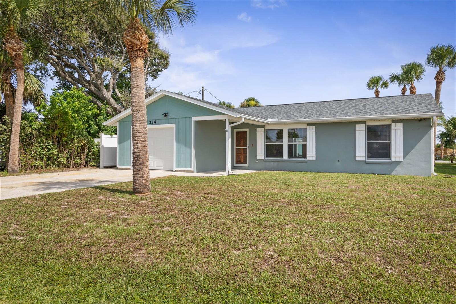 Beautifully updated 2-bedroom, 2-bath beach home located in the heart of Flagler Beach, just a short walk from the Cinnamon Sand Beach, the pier, town center, restaurants, and scenic walking trails. This move-in ready property features an open floor plan and a fully remodeled kitchen with beautiful wood cabinets, granite countertops, and a gas stove. The home also offers new luxury vinyl plank flooring throughout, along with fully updated bathrooms. The spacious master suite provides a comfortable retreat, while the glass-enclosed Florida Room allows for year-round enjoyment with abundant natural light. Major upgrades include a newer HVAC system (installed in 2022) and a roof replaced in 2017.
The home includes an oversized one-car attached garage in the front, plus a large detached and fully finished garage/workshop in the rear—complete with air conditioning and 220V power, ideal for projects, storage, or a home workspace. Included in the garage is a portable whole house generator, powerful enough to run the A/C, refrigerator, TV, and appliances all at once, providing comfort and security during storm season. The expansive outdoor space features a private irrigation well, newer sprinkler system, outdoor shower, and a small fenced-in area perfect for your furry pet. A 700 sq. ft paver patio with a built-in bar creates the ideal setting for entertaining. After a day at the beach or in the workshop, relax with friends around the shimmering glass fire pit and enjoy the best of Flagler Beach coastal living. This is beach life at its finest, don’t miss your chance to see it!