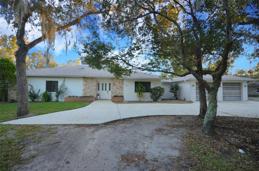 Country  Home on 2.5 acres located off of Turnbull Bay Rd.  This open floor plan offers room for entertaining.  From the moment you walk thought the door the foyer opens to a large glass atrium in the center of the house.   The lighting throughout the living area is spectacular.  Atrium currently houses some tropical plants however, vegetables are another option.   The exercise room has one mirrored wall with French doors that open to the living area.  Kitchen is very large with a walk-n pantry and room for breakfast table in front of the window overlooking the front landscape.  Each bedroom offers windows viewing the wooded setting.  The guest baths as well as the master bath offer large vanities with dual sinks.   Master has a bidet , step in shower and separate tub.   Laundry off kitchen and access from the garage offers separate toilet and shower.   Property is partially cleared with large work shed and large commercial refrigerator.  (not warranted).  The recreation room off the back of the house has a sunk-in tub, outdoor grill and steam room (not warranted).  The kitchen and bath rooms are original,  House has been freshly painted inside and out.   Short distance to the Beach and all the shopping from New Smyrna Beach to Port Orange. ;Water: City