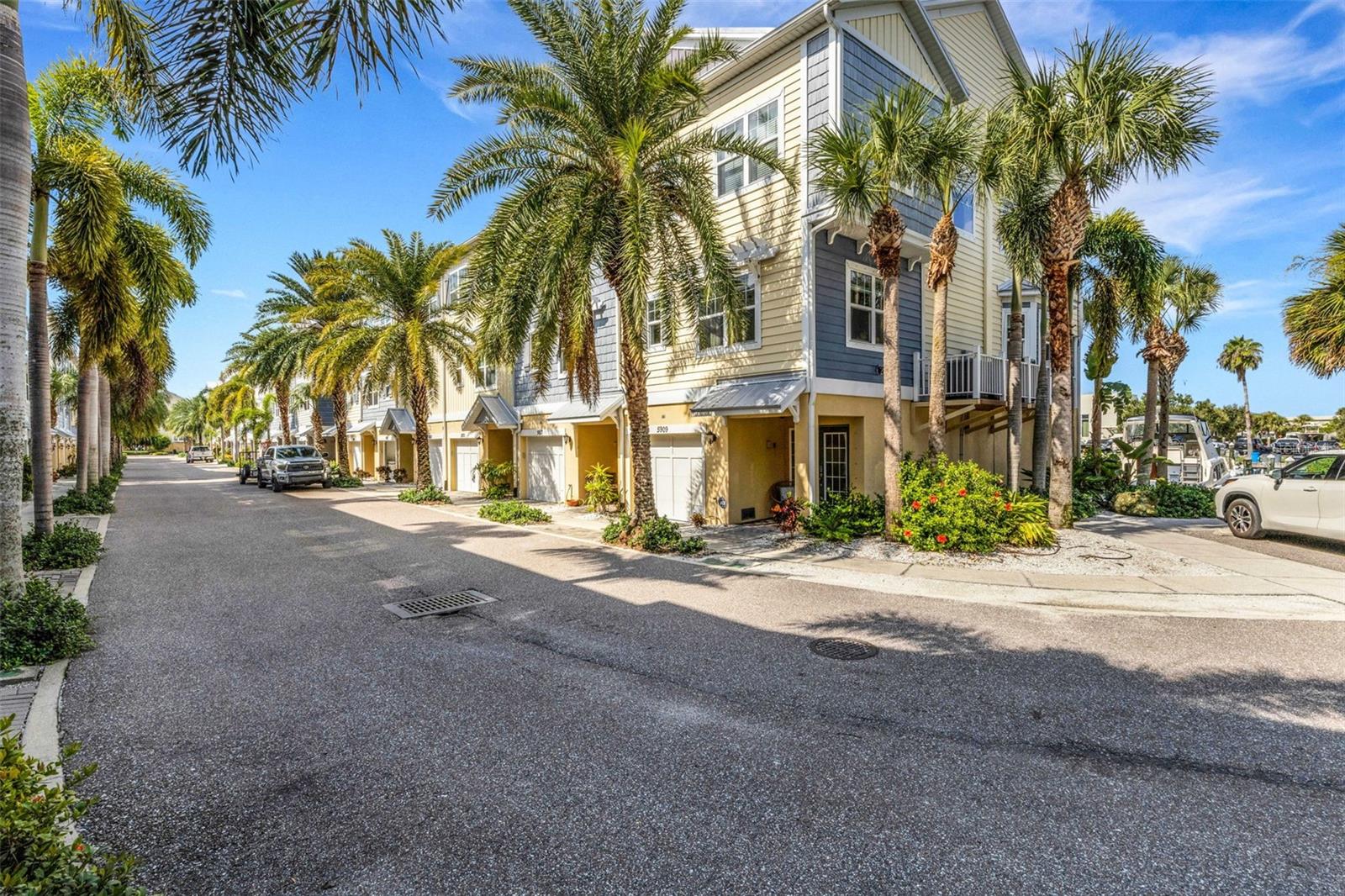 Welcome to effortless coastal living in this elegant end-unit retreat in The Cove at Loggerhead Marina—originally the model home of the community, chosen for its prime location and thoughtful upgrades. Surrounded by boats and just steps to the pool, clubhouse, tiki hut, and guest parking, this residence blends everyday comfort with a true resort-style lifestyle. Featuring water views throughout; stand-out custom decorative touches such as unique bamboo-look, full-wall wainscoting along the stairs and crown moulding; a private in-unit elevator and 2-car tandem, climate-controlled garage with space for workshop or a gym, this home has been impeccably maintained. The open main level showcases a lovely kitchen with quartz counters, cabinetry pull-outs, custom tile backsplash, stainless appliances, wood cabinetry, and spacious pantry with upgraded wood shelving. The living and dining areas are filled with natural light from end-unit windows and open onto a screened balcony overlooking the marina featuring electronic, remote-controlled shades - perfect for morning coffee or evening sunsets. A versatile guest bedroom with a full bath is also on the main floor, ideal as an office or den. The primary suite on the upper level is a retreat with serene water views, sitting area, oversized walk-in closet, dual vanities, tile walk-in-shower. Two additional bedrooms, a full bath, and a laundry room complete the upstairs. Additional features include stunning custom lighting, a water softener system. Recent updates include a newer A/C (2023), new luxury vinyl flooring (2024), and epoxy garage floors (2024). Outdoor living shines here with a second covered patio off of the garage with direct access to the marina docks. Residents enjoy the security of a gated community, flood insurance included in HOA, the ease of dock slips (upon availability), dry storage or Freedom Boat Club at your doorstep. Loggerhead Marina’s protected harbor offers quick access to the Gulf, while the Pinellas Trail runs alongside for biking, walking, and jogging. Perfectly located just 10 minutes to St. Pete Beach, 15 minutes to vibrant Downtown St. Petersburg, and about a half hour to Tampa International Airport, just over the Sunshine Skyway Bridge to access Anna Maria Island, Sarasota and Bradenton - this townhome offers the ultimate blend of convenience and coastal serenity. Turnkey and available furnished with tasteful coastal décor - it's time to start living your permanent vacation in this fabulous home.
