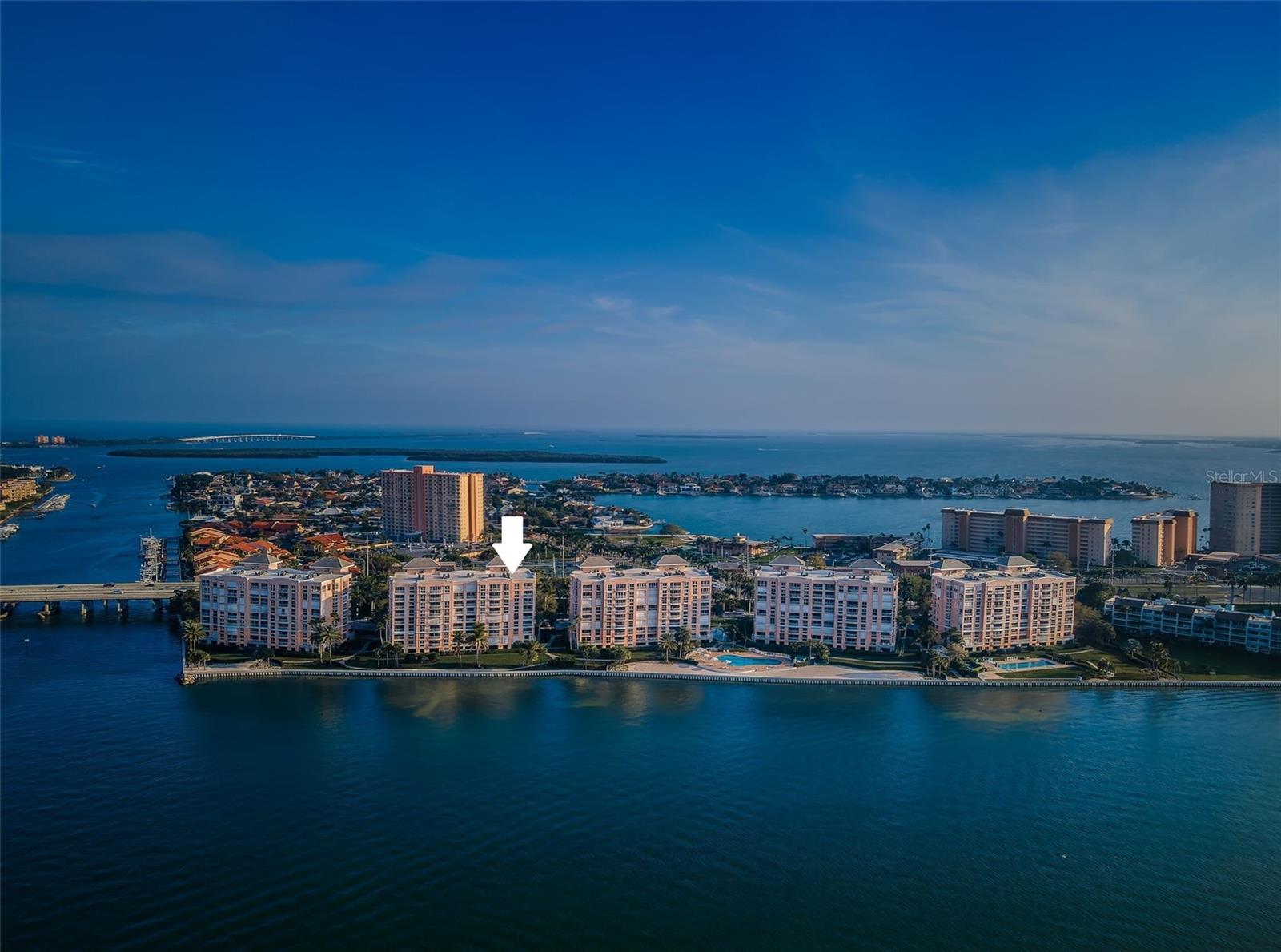 RARE WATERFRONT PENTHOUSE - BACOPA BAY CONDO. 4 Bedroom -3 Bath With over 3000 Sq Feet of Living Space . Outstanding Panoramic Long Range Water Views Over Boca Ciega Bay from every Room & Balcony of this Luxurious Penthouse... Just a Wonderful Floorplan For Entertaining. High end Construction - 24 Hour Guard - Gated Community - Developed by JMC Properties. 8th Floor Penthouse Conveys with Private 600 Sq Ft Entry Landing to Grand Foyer. Only Unit on 8th Floor Landing. Waterfront Balconies off of the Great room / Dining room - Primary Bedroom Suite and 3rd Bedroom Suite. Spacious Open Floorplan with 10 ft. Ceilings Thru out Unit- including the Private 600 Sq Feet Landing. Travertine & Carpeted Flooring, Plantation Shutters & Electric Storm Shutters on All Openings., Custom Cabinetry & Crown Molding - Indirect Lighting & Custom Fixtures. Spacious large Open Kitchen - Breakfast Bar - Center island - Granite Countertops, Tons of Closet & Pantry Space. 4th Bedroom Currently being used as a 13' x 12' Office / Flex Room. Private Secured Grounds - Conveys with Garage Spot # 4 by Lobby plus Carport Spot # 38. Bacopa Bay Community offers Resort-style Amenities that include Tennis Courts, Two Pools ( one Lap Pool ) a Fitness Center, Clubhouse and Lagoon with Waterfall - Tropical Landscaped Grounds - Ideally located Close to Gulf Beaches, Ft Desoto Park, Minutes to all the Venues of Downtown St. Petersburg and 30 minutes to Tampa Int’l Airport. Prior Owner - Vince Naimoli of the Tampa Bay Rays. He Could see Tropicana Field from the NE Balcony .. You Gotta love it. Bedroom Closet Type: Walk-in Closet (Primary Bedroom).