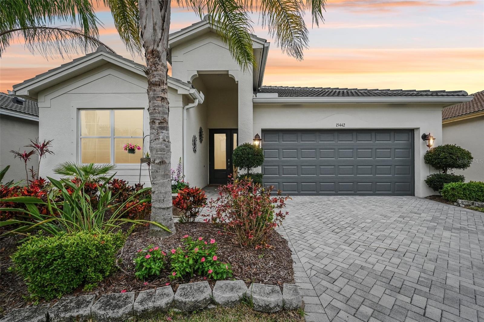 NO CDD FEE! Discover the perfect blend of luxury, comfort, and active adult living in this beautifully upgraded home located in the highly sought-after Valencia Del Sol 55+ community in Wimauma, Florida. Ideally situated on a premium south-facing waterfront homesite, this residence offers abundant natural light and peaceful water views that create a serene backdrop for everyday living. Step inside to find a thoughtfully designed, open-concept split floorplan that combines elegance with practicality. The gourmet kitchen is a standout feature, complete with 42” linen maple cabinetry, granite countertops, and upgraded GE appliances—perfect for cooking and entertaining. Crown molding throughout the home adds a refined touch, while custom closets and laundry room cabinetry enhance functionality and storage. The spacious great room flows seamlessly to the outdoors through triple 8-foot pocket sliders, opening onto a covered lanai overlooking tranquil water views—your personal oasis for morning coffee or evening relaxation. Valencia Del Sol offers a resort-style lifestyle with world-class amenities, including a sprawling clubhouse, social hall with live music, on-site restaurant, resort pool and spa, pickleball and tennis courts, fitness center, arts and crafts studio, and a full-time lifestyle director curating a packed calendar of events and activities. Located just minutes from Sun City Center, you’ll enjoy convenient access to shopping, dining, healthcare, and everything you need for a vibrant, low-maintenance lifestyle. This is more than a home—it’s a gateway to your next adventure in paradise. Schedule your private showing today and experience all that Valencia Del Sol has to offer!