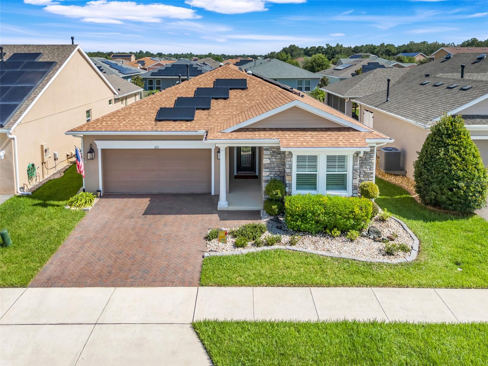 Experience resort-style living in The Cascades of Groveland, also known as Trilogy —one of Central Florida’s most sought-after 55+ communities. This gated, guard-secured neighborhood offers an unmatched lifestyle with a 57,000+ square foot clubhouse, indoor and outdoor pools, a world-class fitness and wellness center, tennis and pickleball courts, walking trails, an artisan studio, a full-service restaurant and bar, and a vibrant calendar of social events and activities. Here, every day feels like a vacation.
Set within this exceptional community, you’ll find a beautifully maintained home that combines comfort, efficiency, and elegant design. From the moment you enter, a spacious foyer welcomes you with warmth and character. To the right, a bright guest bedroom and full bath offer privacy for visitors, followed by a large office with French doors—perfect for working from home or enjoying a quiet retreat.
At the heart of the home is an open-concept kitchen, dining, and living area that flows seamlessly together. The kitchen features rich cherry wood cabinetry, gleaming Silestone counters, an oversized island, stainless steel appliances including double ovens, and a backsplash for a touch of sophistication. A built-in bar area is framed by custom cabinetry, offering both beauty and function.
Wide-plank hardwood flooring and plantation shutters add timeless charm throughout the living spaces. The sunroom, enclosed with glass and overlooking the backyard, provides a cozy, climate-controlled space to relax year-round.
The primary suite is privately tucked at the back of the home and features a beautifully renovated en suite bath and a spacious, custom walk-in closet with built-ins for optimal storage and organization.
Energy efficiency is a standout feature, thanks to the owned solar panel system that delivers impressively low electric bills. Step outside to a tranquil backyard retreat, complete with a paver patio, wood pergola, firepit area, and lush, well-maintained landscaping. A privacy fence runs along the back of the property, creating a peaceful and private outdoor space.
This home offers thoughtfully designed living, energy savings, and access to a lifestyle that many only dream of. And when you want to explore beyond your doorstep, you're just a short drive from shopping, dining, and entertainment in Clermont—with Orlando, major highways, and world-class attractions conveniently close. Whether you're enjoying everything Trilogy has to offer or heading out for a night on the town, the best of Central Florida is right at your fingertips.
Schedule your private showing today and experience this incredible property for yourself.