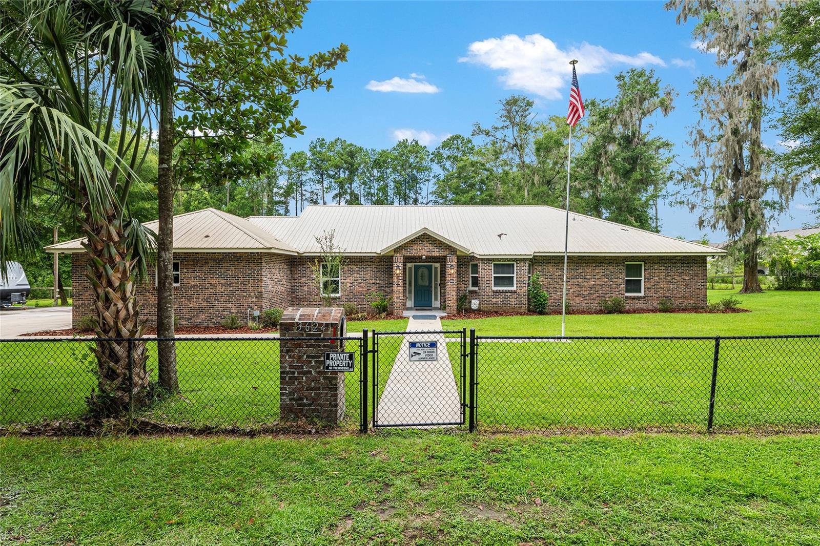 Custom 2017 Brick Home on 1 Acre In-Town – Loaded with Upgrades! Welcome to this beautifully maintained 3-bedroom, 2-bath custom brick home located on a full acre in a prime in-town location with NO HOA! This nearly 2,300 square foot home offers an open layout with vaulted ceilings, crown molding, built-in speakers, and two cozy gas fireplaces—one in the living room and another in the spacious primary suite. The well-appointed kitchen features granite countertops, subway tile backsplash, stainless steel appliances, under-cabinet lights, sleek range hood, walk-in pantry and custom soft-close cabinetry. A separate formal dining room that includes a built-in glass cabinet with interior lighting and breakfast bar offer plenty of dining options. Vinyl plank flooring in main living areas, tile in kitchen and bathrooms and carpet in bedrooms. A dedicated inside laundry room offers extra convenience. Oversized primary bedroom with plenty of room for large furniture, a gas fireplace and handicap accessible bathroom with walk-in shower and a double sink vanity with granite. Enjoy low utility bills thanks to energy-efficient Isonene insulation, well and septic, and a durable metal roof. The 3-car garage provides ample storage, and there’s even a 20x30 RV pad with septic cleanout, security light, and gated access. Outside you will find a flagpole, brick mailbox, security lights and a security system. The home is whole-home generator-ready and has natural gas running to the home. Unwind on the expansive screened-in back porch, fully wired for a hot tub and TV—perfect for watching west-facing sunsets. Additional features include a fully fenced yard, irrigation system, and top-rated school zones. Conveniently located near I-75, shopping, dining, and hospitals. Pool table negotiable with sale. Don’t miss this rare combination of space, upgrades, and location!