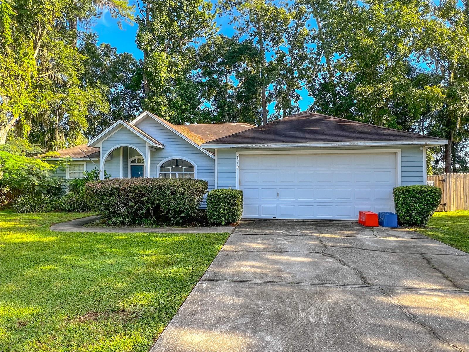 Welcome to this charming 3-bedroom, 2-bath home in the desirable Idylwild Lane neighborhood of SW Gainesville! Featuring a spacious open floor plan, the home boasts a bright kitchen with ample cabinet space, a breakfast bar, and an adjacent dining area that flows into the large living room with vaulted ceilings. The split-bedroom layout offers privacy, while the primary suite includes generous natural light and a walk-in closet. Enjoy a fully fenced backyard shaded by mature trees—perfect for relaxing or entertaining. Additional highlights include a two-car garage, indoor laundry room, and convenient location close to schools, parks, shopping, and UF. 2 pets welcome. Students welcome. Lawn Care included.
