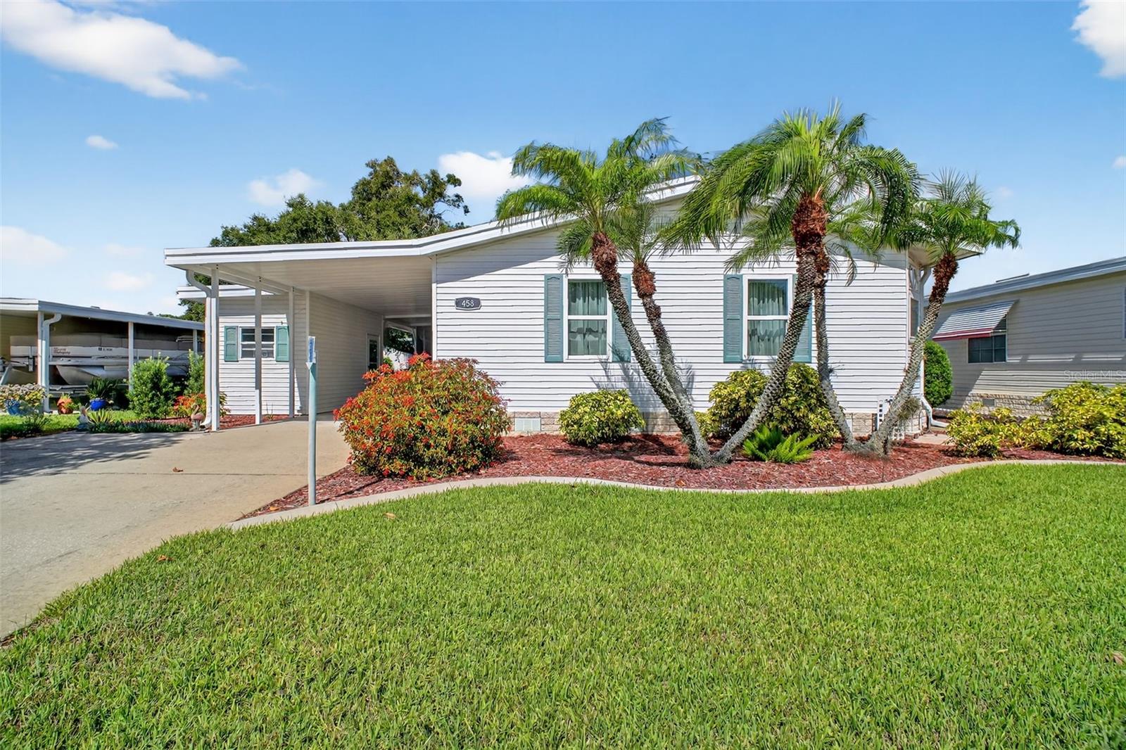 Here is your opportunity to own an impeccably maintained 2-bedroom 2-bath home in the sought-after Fox Run Community.
As you walk in, you notice the open and airy feeling enhanced by the home's cathedral ceilings, neutral colors, natural light, and open floor plan. The living area that includes a formal dining area leads into the spacious remodeled kitchen with its stainless steel appliances, new cabinets, countertops, fixtures, and sink, affording you plenty of storage and prep area. Whether you choose to enjoy a meal at the breakfast bar or the kitchen's dining area, you will enjoy the outdoor views by the surround of windows and sliding glass door access to the covered screened porch, and your access to the backyard. The split floor plan locates the primary suite to the front of the home. The large bedroom with plenty of closet space opens into the dressing area and remodeled bath area with twin sinks, and a glass-enclosed step-in shower. The second bedroom, located at the back of the home, affording privacy when company visits, is just steps away from the remodeled guest bathroom. The carport has been extended to include a workshop/storage area as well as an additional outdoor sitting area. for yet another area to enjoy the outdoors, all with plenty of room for your golf cart. Landscape curbing and mulch walk areas further enhance the home's curb appeal and access to the beautifully landscaped, shaded back yard. Additional improvements include the installation of insulated windows and a sliding glass door, with designer Levelor window shades, Armstrong laminates throughout the home, and a 24-gauge metal roof installed in 2018, to name a few. Enjoy all of the social activities that Fox Run has to offer, situated around the clubhouse and two pools, while you enjoy access provided by its marina and boat ramp to the "Harris Chain of Lakes". Call today to arrange for your private showing.