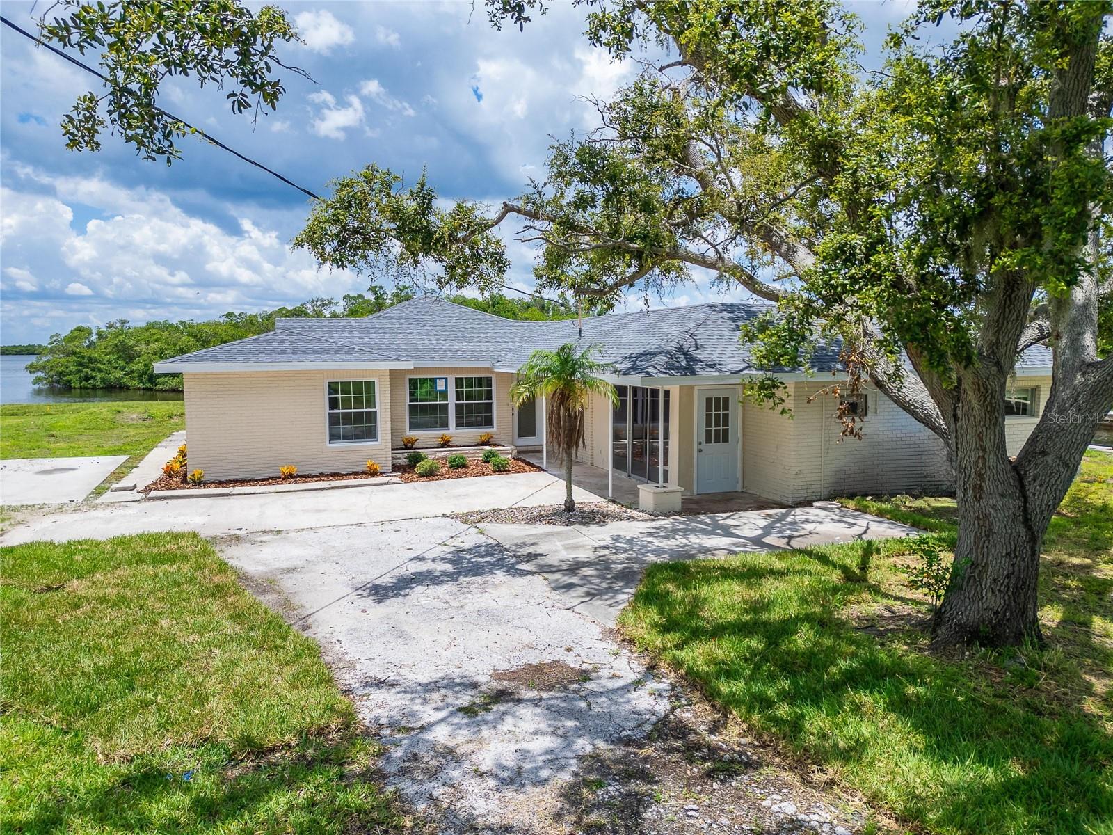 Bayfront Property with 275 feet of seawall. Enjoy stunning water views, a vast front and back yard, and the convenience of your own private boat slip. Located just minutes from major highways, Cockroach Bay Reserve, Gulf City Road, and Lost River Preserve, this home is a haven for nature and boating enthusiasts alike. This spacious 4-bedroom, 3-bathroom waterfront home offers 2,010 square feet of living space on over half an acre, situated on a private corner lot and the property includes an attached in-law apartment with separate access, ideal for extended family, guests, or a private office. Inside, you'll find updated bathrooms and a modern kitchen, all designed to maximize comfort and function. Lawn maintenance and water are included in the rent, offering added value and ease of living. This rare opportunity combines privacy, functionality, and waterfront living all in one. *If accepted, a $150 tenant processing fee will be collected at application acceptance