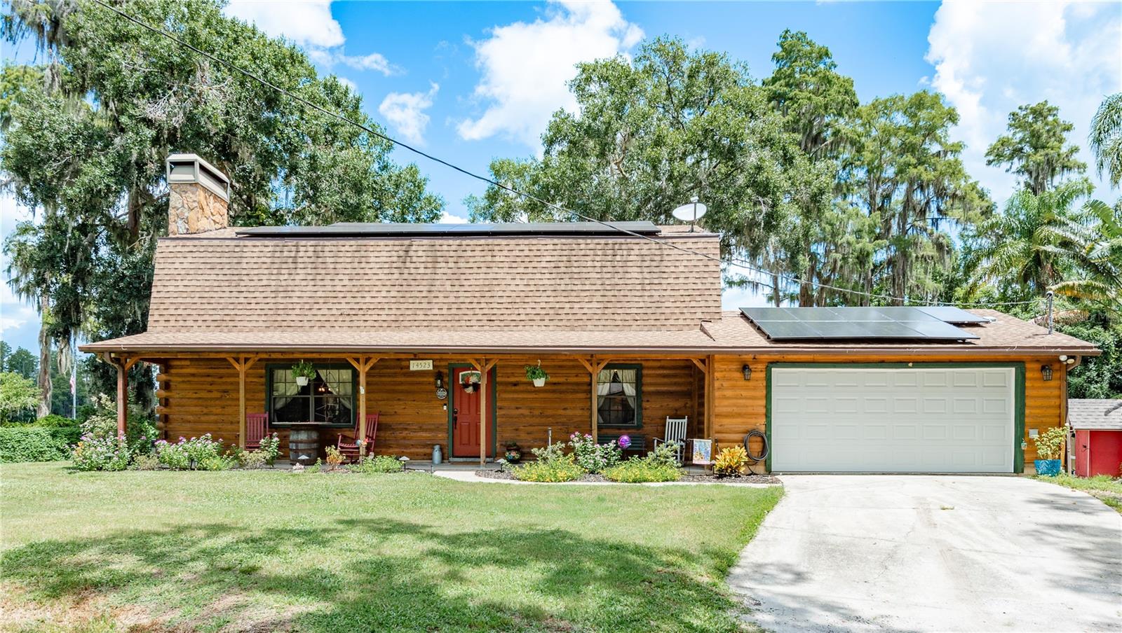 LakeFront Living can be Yours! Welcome to this Cozy Upgraded Cabin on the Lake! Situated on almost a half acre lot, this home is filled with updated Rustic Charm and Gorgeous Views! Your guests will immediately feel welcome when they arrive and see the inviting Front Porch with plenty of room for conversations! Enter in the large Living Area with Stone Accented Fireplace. The Kitchen has updated cabinetry and beautiful Quartz countertops with coordination color accents! The appliances were replaced in 2023 and there is a reverse osmosis system too! The expanded Kitchen allows plenty of room for a coffee bar, etc. The 4th Bedroom is on the main floor and is great for Guests or a Home Office! The 1st Floor Bath has a jetted tub and updated vanity and sink. Upstairs you will see the spacious Primary Bedroom with a wonderful water view. Enjoy 2 large closets and lots of space! The upstairs Bathroom was remodeled in 2023 and adjoins the Primary Bedroom. The other secondary bedrooms are a nice size and 1 has a walk in closet too! The Glass enclosed Sun Room is fully integrated with the home and features a spectacular LAKE VIEW! This room is multi-functional and great for entertaining! Outside enjoy both the covered lanai and open pavered patio. The dock has been redone and features a floating deck. With 100 ft of frontage imagine the Fun you will have fishing or just enjoying a day on the Lake! This property has no HOA so bring your Boat / RV / etc. There are currently resident Chickens too! Take a Look soon before it is gone!