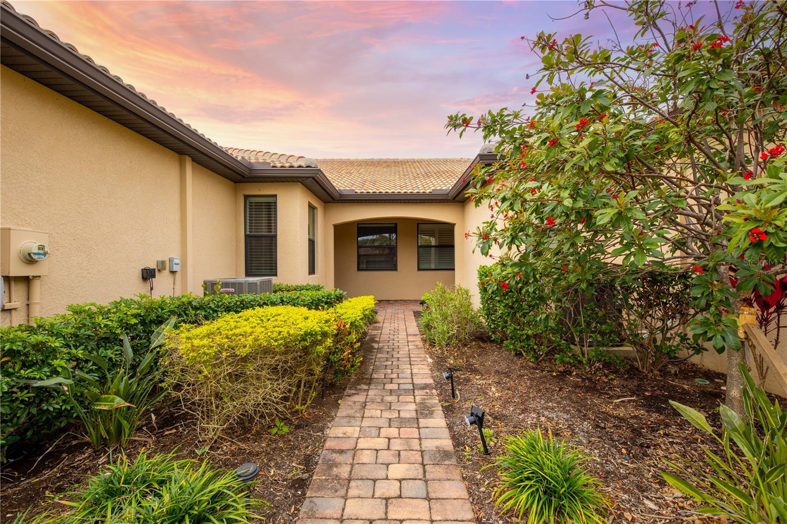 Now available for rent in the highly desirable gated community of IslandWalk at Wellen Park starting October 1st! This beautifully maintained Seagrove Model villa offers 2 bedrooms, 2 bathrooms, and a flexible bonus room that can be used as an office, den, craft space, or even a third bedroom. With tile flooring throughout the main living areas and luxury vinyl plank flooring in the bedrooms, this home blends comfort and durability for easy Florida living. The open-concept kitchen features granite countertops, solid cabinetry, and flows seamlessly into the spacious living room and private screened lanai—perfect for relaxing or entertaining guests.
The primary suite includes a generous walk-in closet and a luxurious ensuite bathroom with dual sinks, granite counters, and a tiled walk-in shower complete with a built-in bench. The second bathroom features a tiled tub/shower combo for added convenience. This rental also includes a laundry closet with a newer washer and dryer, a 2-car attached garage, 8-foot doors, and hurricane shutters for peace of mind.
IslandWalk is a vibrant, amenity-rich community offering two resort-style pools, a lap pool, 12 pickleball courts, 8 Har-Tru tennis courts, bocce ball, a state-of-the-art fitness center, community garden, library, playground, and dog parks. Residents also enjoy a full calendar of events and activities organized by a full-time lifestyle director. A private, resident-only back gate offers direct access to Downtown Wellen, Publix, Costco, restaurants, shopping, and CoolToday Park—home of the Atlanta Braves—without ever needing to get on Highway 41. This is a fantastic opportunity to rent in one of Venice’s most sought-after communities. Don’t miss your chance to live in this community—schedule a showing today!
