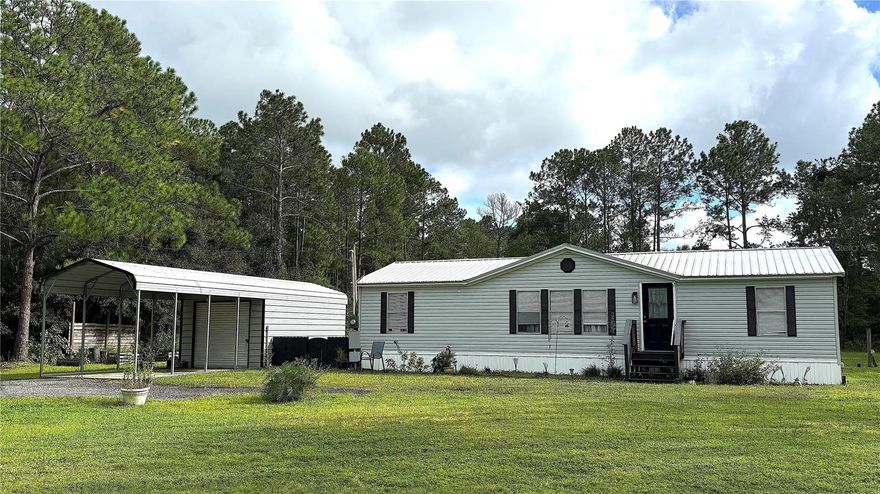Live Your Best Life TODAY! This Newly Updated Retired Modular Has It All. Boasting in the Rural Lifestyle of Flagler Estates Where Privacy, Trees and No HOA's All Add to A Simpler Way of Life. This Three Bedroom, 2 Bath Coastal Style Ranch Has Modern Updated Finishes and Improved Sought After Features Including: Detached Garage Carport with Electric Panel, 23x14 Expanded Enclosed Rear Screened in Deck, New Electric Panel, New Water Softener System with Commercial Pump, Complete RV hook-up (water, septic and 30 amp), Completely Fenced In with Additional Pet Friendly Fencing and Stone Paver Walkway to Rear Entrance. Come and Get Your Own Piece of Sunshine in This Gem TODAY!